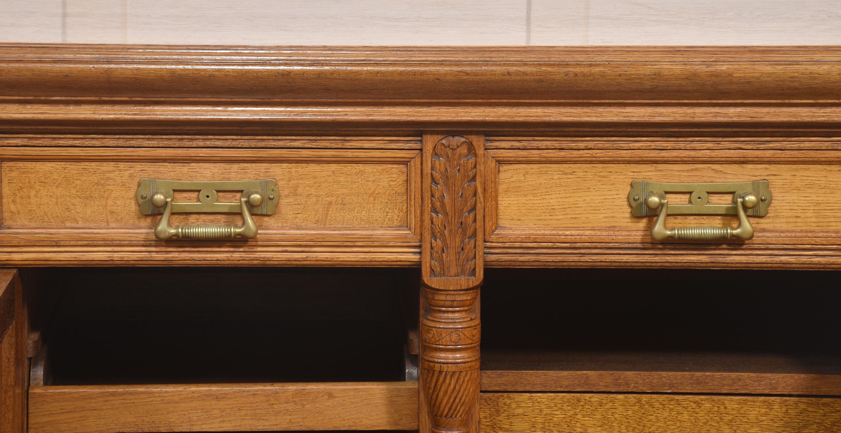 19th Century Carved oak two door sideboard by Maple and Co For Sale