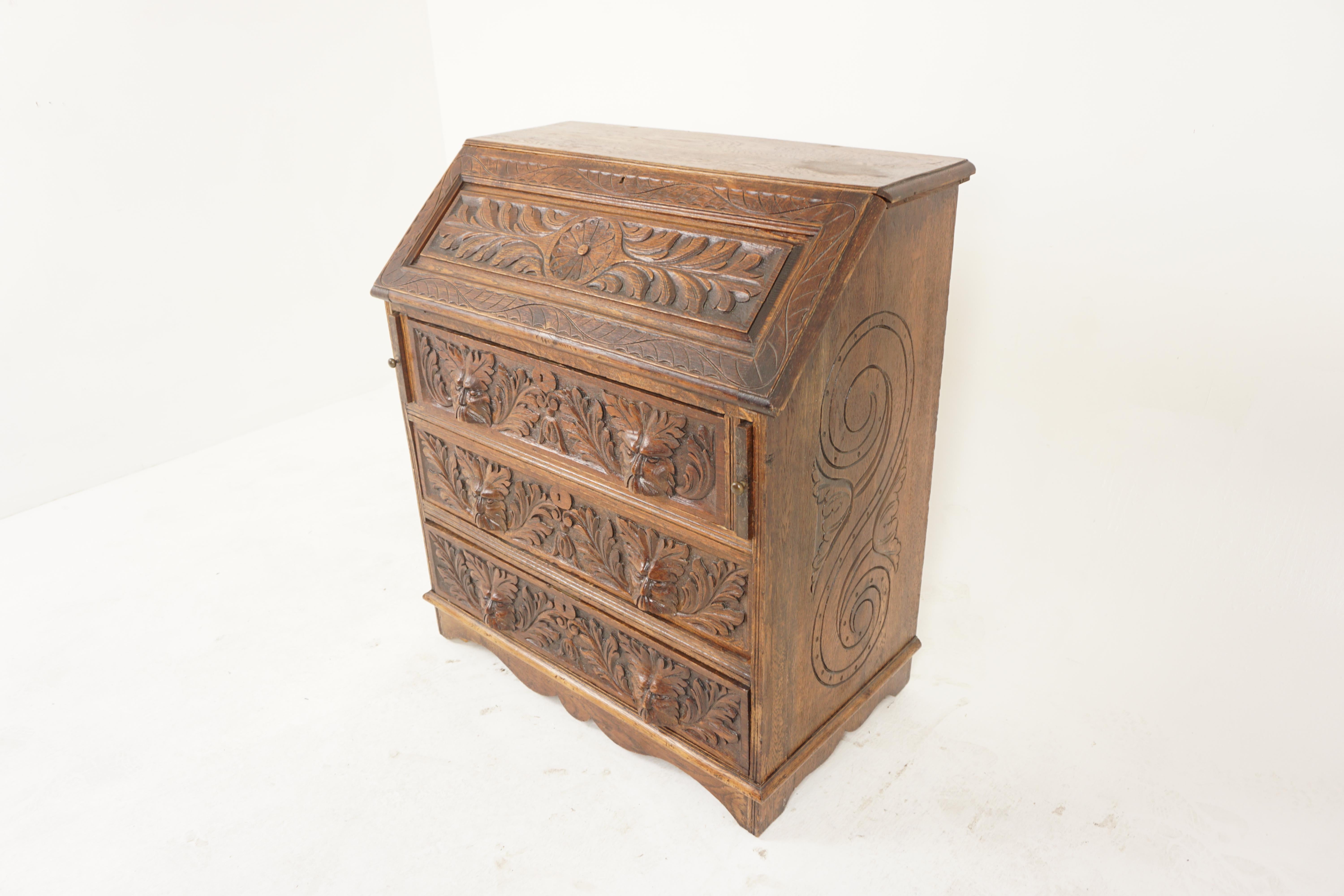 Carved Oak Victorian Green Man Fall Front Desk Bureau, Scotland 1880, H1170

Solid Oak
Original finish
Rectangular moulded top with bevelled edge
Carved fall front with foliate carving
When opened it reveals a fitted interior with three pigeon holes