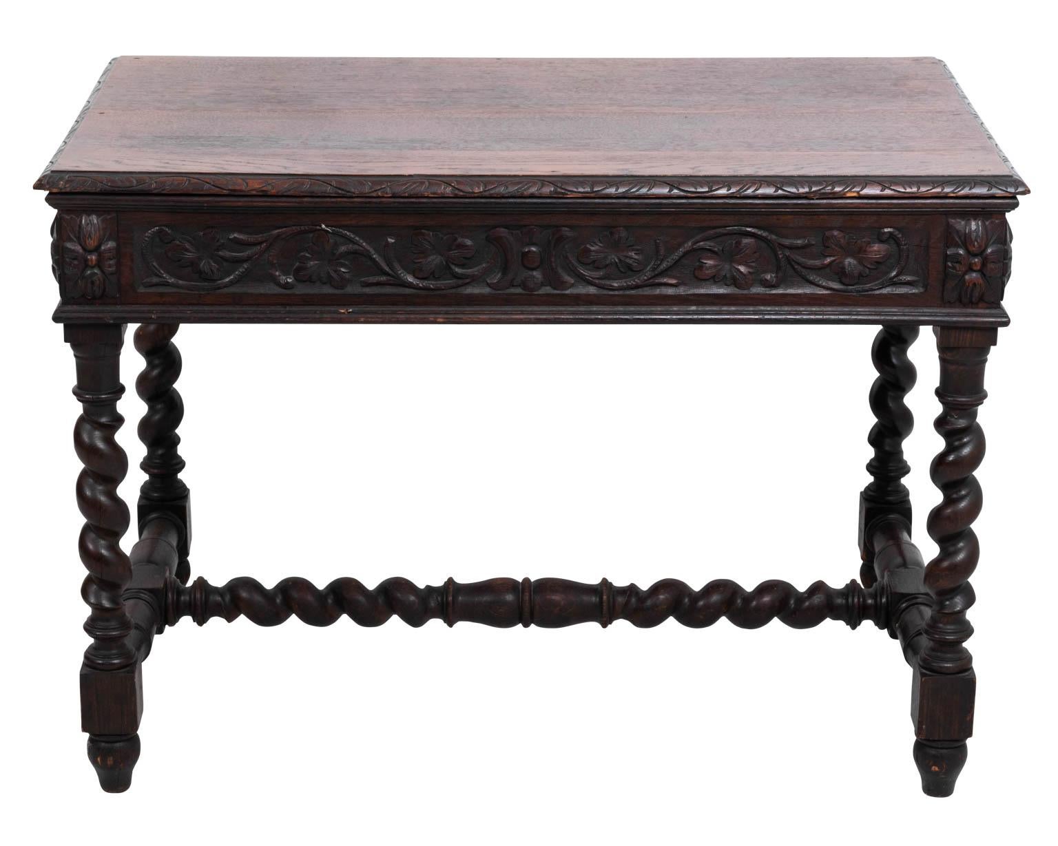 Carved oakwood one drawer table with barley twist legs and H-shaped cross stretcher. The piece also features carved figures on the drawer fronts. Please note of wear consistent with age including chips, dents, and finish loss.