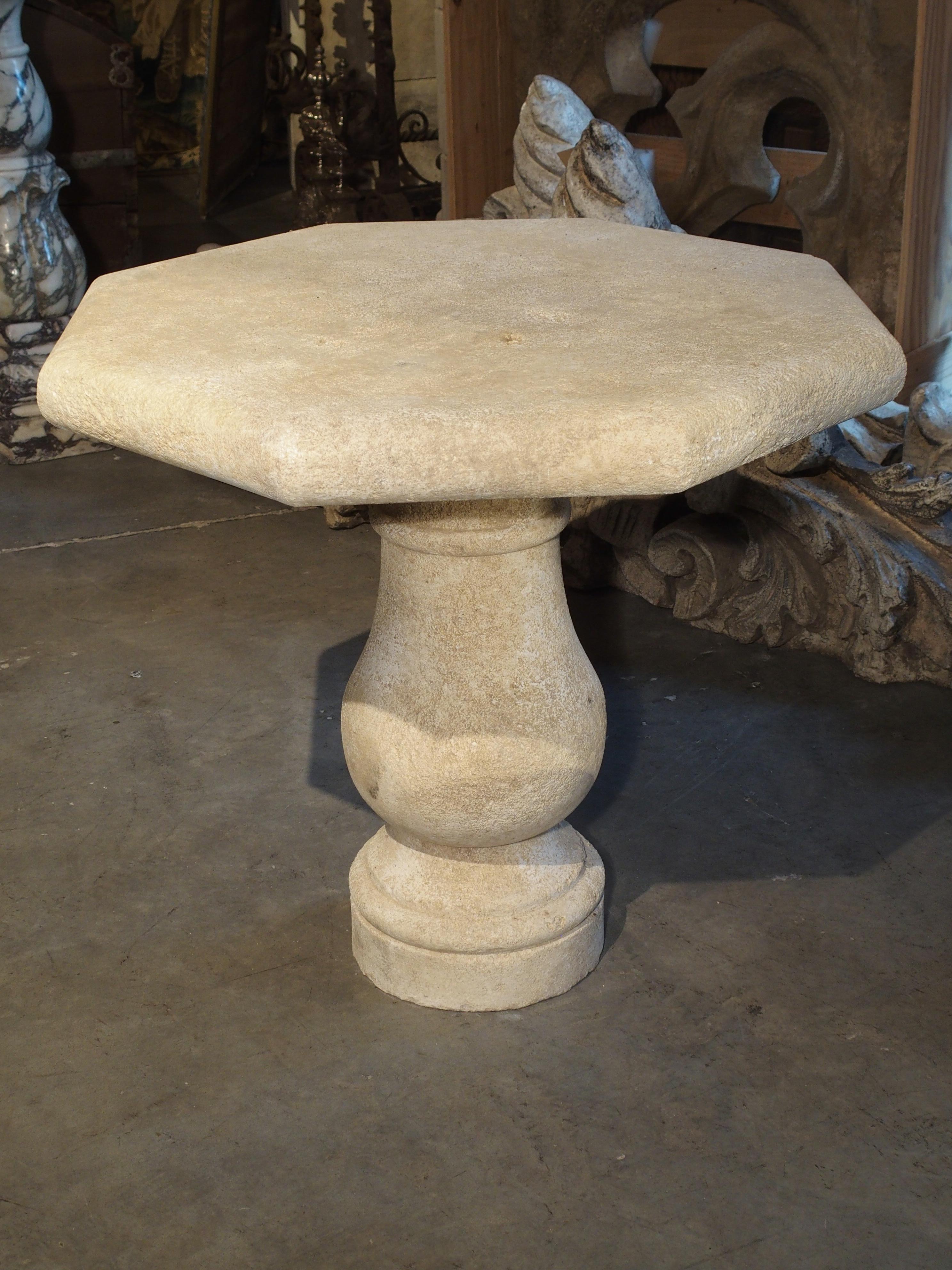 This charming stone table has an octagonal top sitting on a shaped baluster leg base. It can be considered a side table, occasional table or short bistro table. It comes from the South of France and has been carved from the famous Estaillade stone