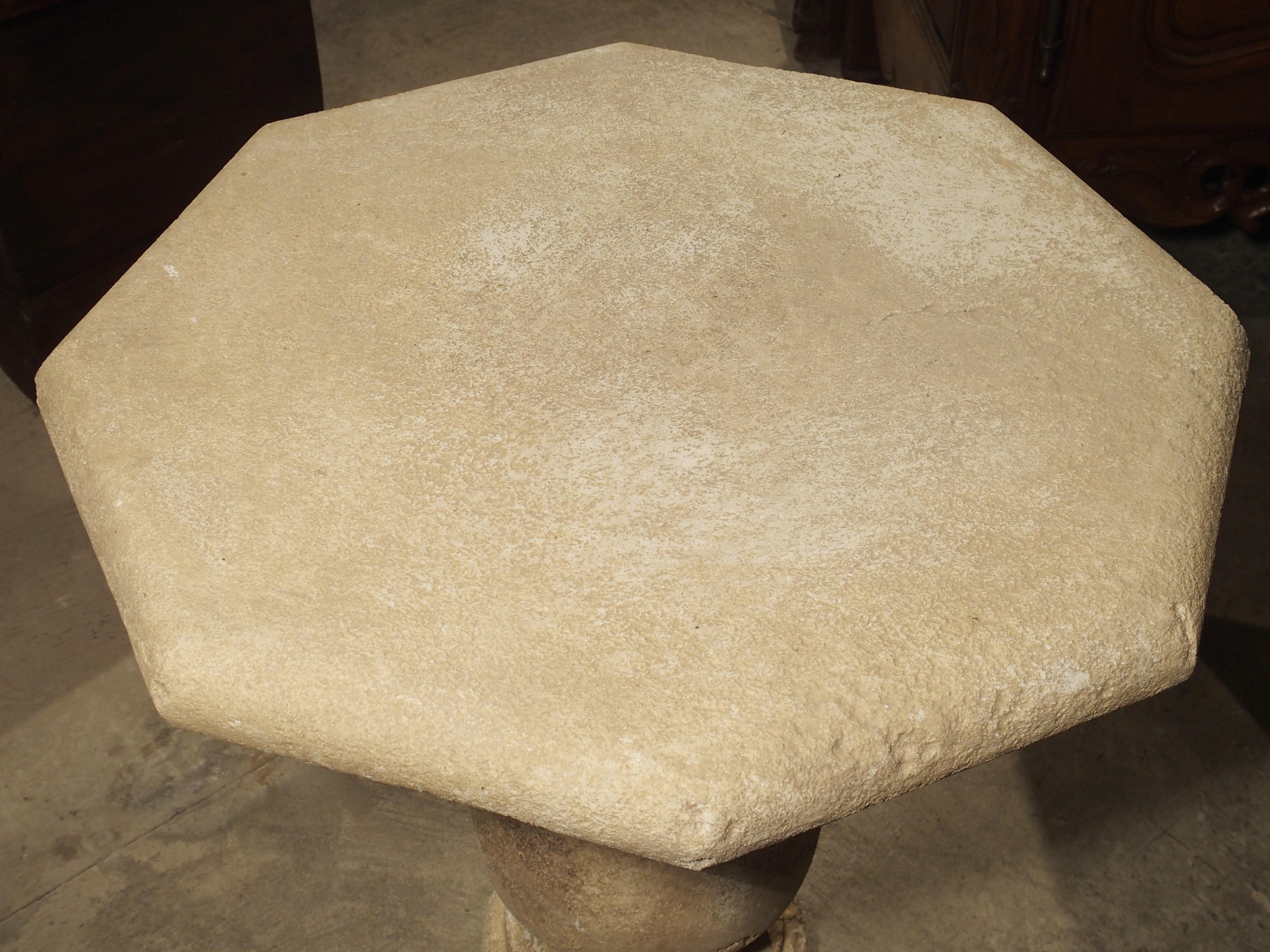 This charming stone table has an octagonal top sitting on a shaped baluster leg base. It can be considered a side table, occasional table or short bistro table. It comes from the South of France and has been carved from the famous Estaillade stone