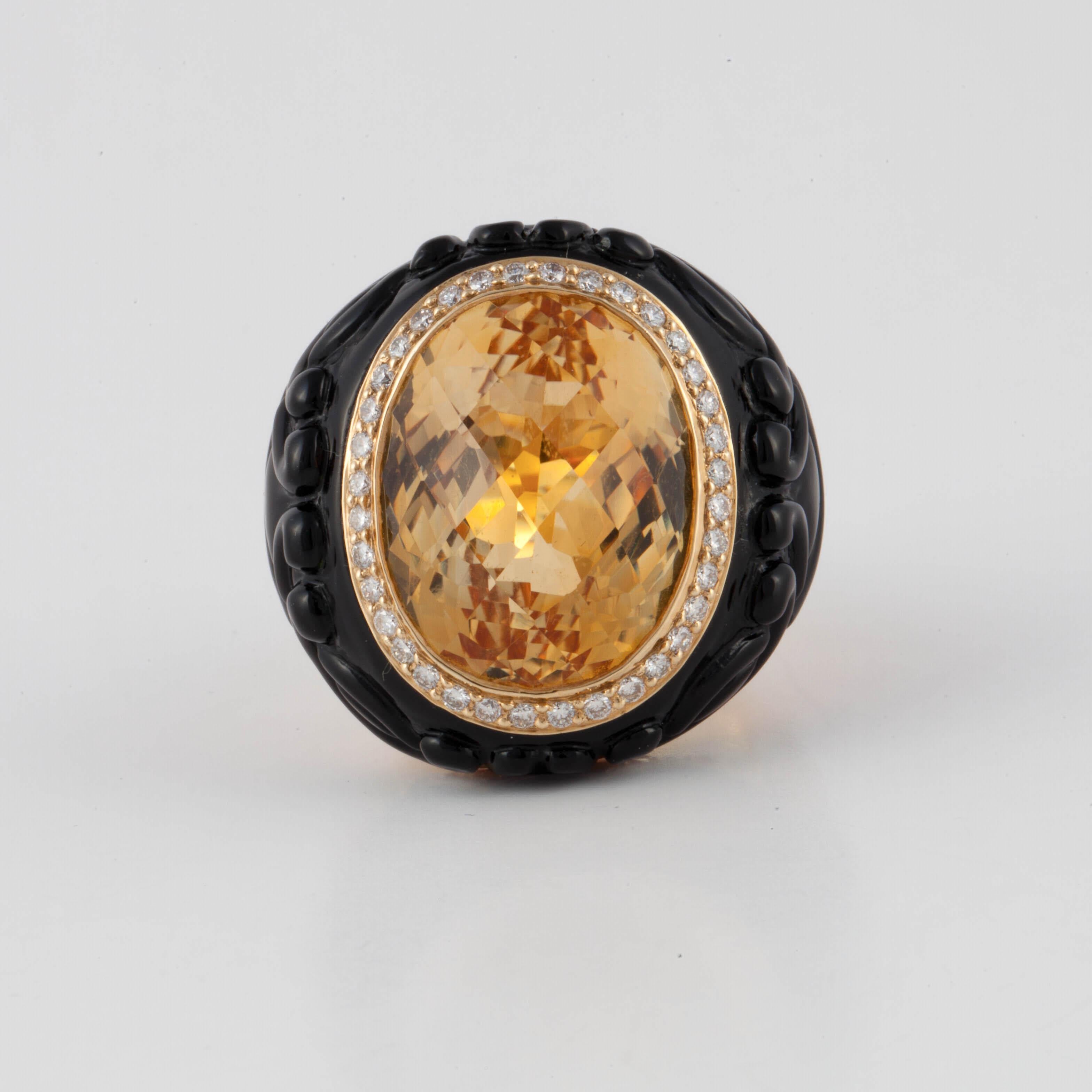 18K yellow gold ring features a citrine stone framed by round brilliant-cut diamonds and carved onyx.  The shank has round orange sapphires totaling 2.40 carats.  Measures 1 1/8 inches long, 1 1/8 inches wide and stands 5/8 inches off the finger.  