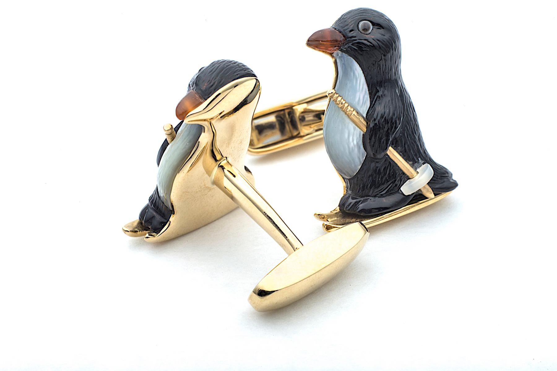 Penguins mate for life and this adorable couple symbolizes that eternal commitment.  Hand carved out of black onyx, mother -of-pearl, and carnelian, these fun loving birds, mounted on 18K yellow gold skis, will remind your soul mate of the