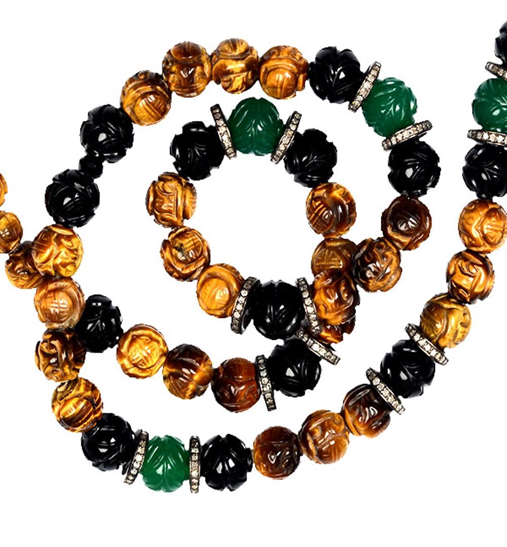 This necklace is meticulously crafted with a combination of two exquisite gemstones, onyx and tiger eye, along with a touch of diamond brilliance.

The centerpiece of this necklace is a series of carefully carved onyx and tiger eye balls. Onyx,