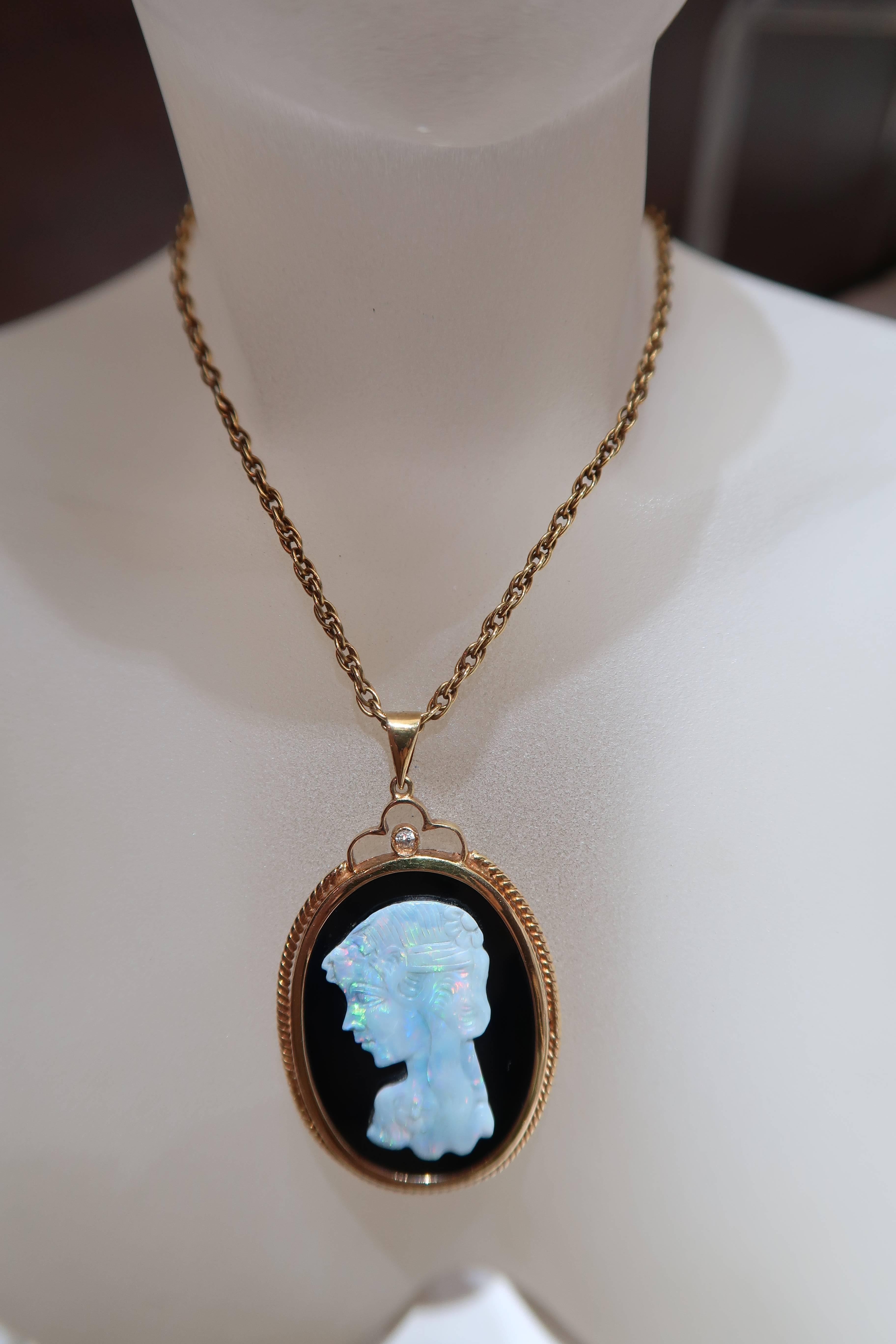Fine carved opal cameo pendant with onyx in 14K yellow gold and 18K yellow gold rope chain.

14K Onyx and Opal Cameo Pendant
Gold : 14K Yellow Gold
Diamond : 1 piece
Opal : 1 piece
Onyx : 1 piece

18K Rope Chain
Gold : 6.088g. 18K Yellow Gold