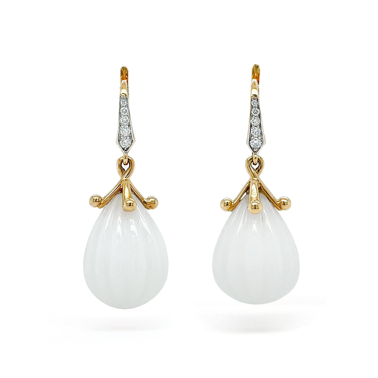 The soft iridescent light of white opal illuminates these earrings. 18k yellow gold lever backs with pave set brilliant cut diamonds feature gold caps with miniature orbs at the tips. Suspending from this is a teardrop cut of white opal with carved
