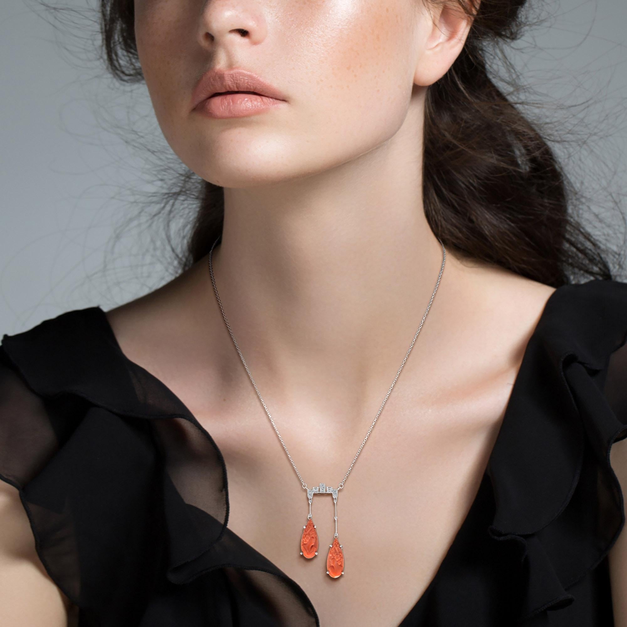 An antique design negligee necklace, so delicate and elegant in its beauty. This style necklace became popular at the turn of the century. It’s features cameo carved coral suspended from the shimmering diamonds top part necklace with different