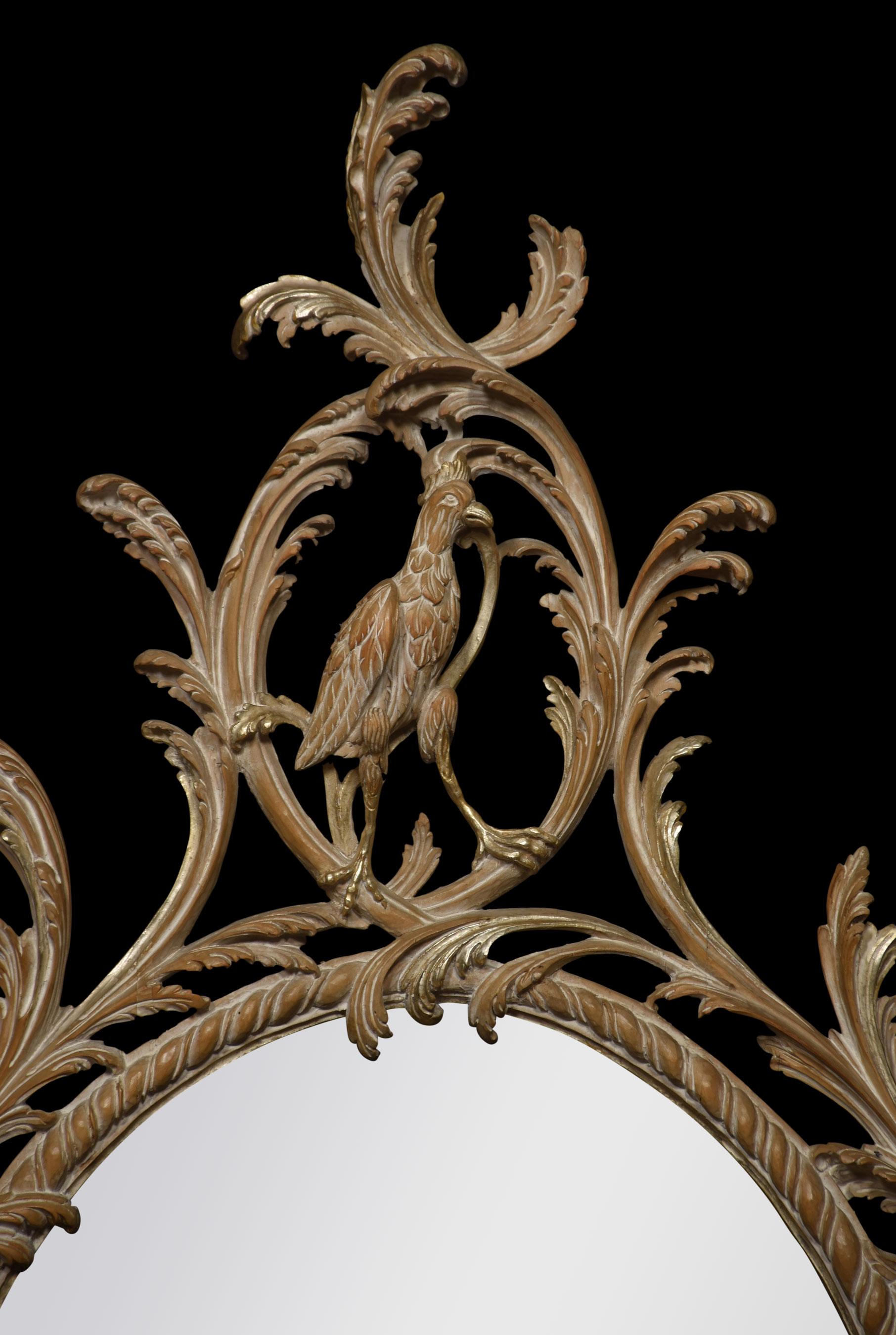 Oval wall mirror in carved and limed frame, the pediment carved with ho ho bird encased in an interlaced foliate branch, decorated with flower heads and trailing bell flowers. Surrounding the original mirror plate.
Dimensions
Height 46