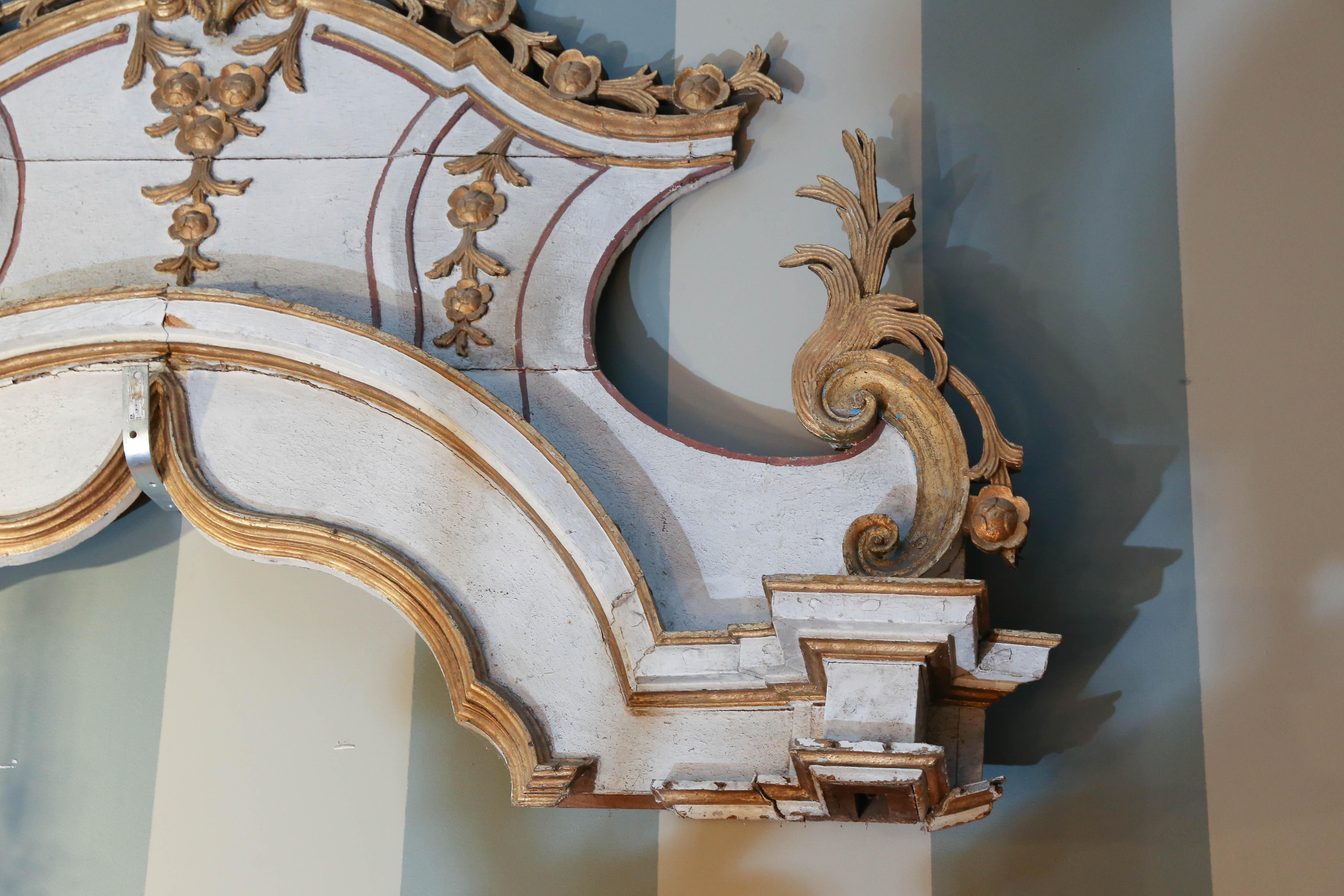 Architectural element is carved, painted, and gilt was possibly an elaborate overdoor.

Piece has great possibilities to be fashioned into a headboard, or any number of interesting items.

Wonderfully eccentric.
