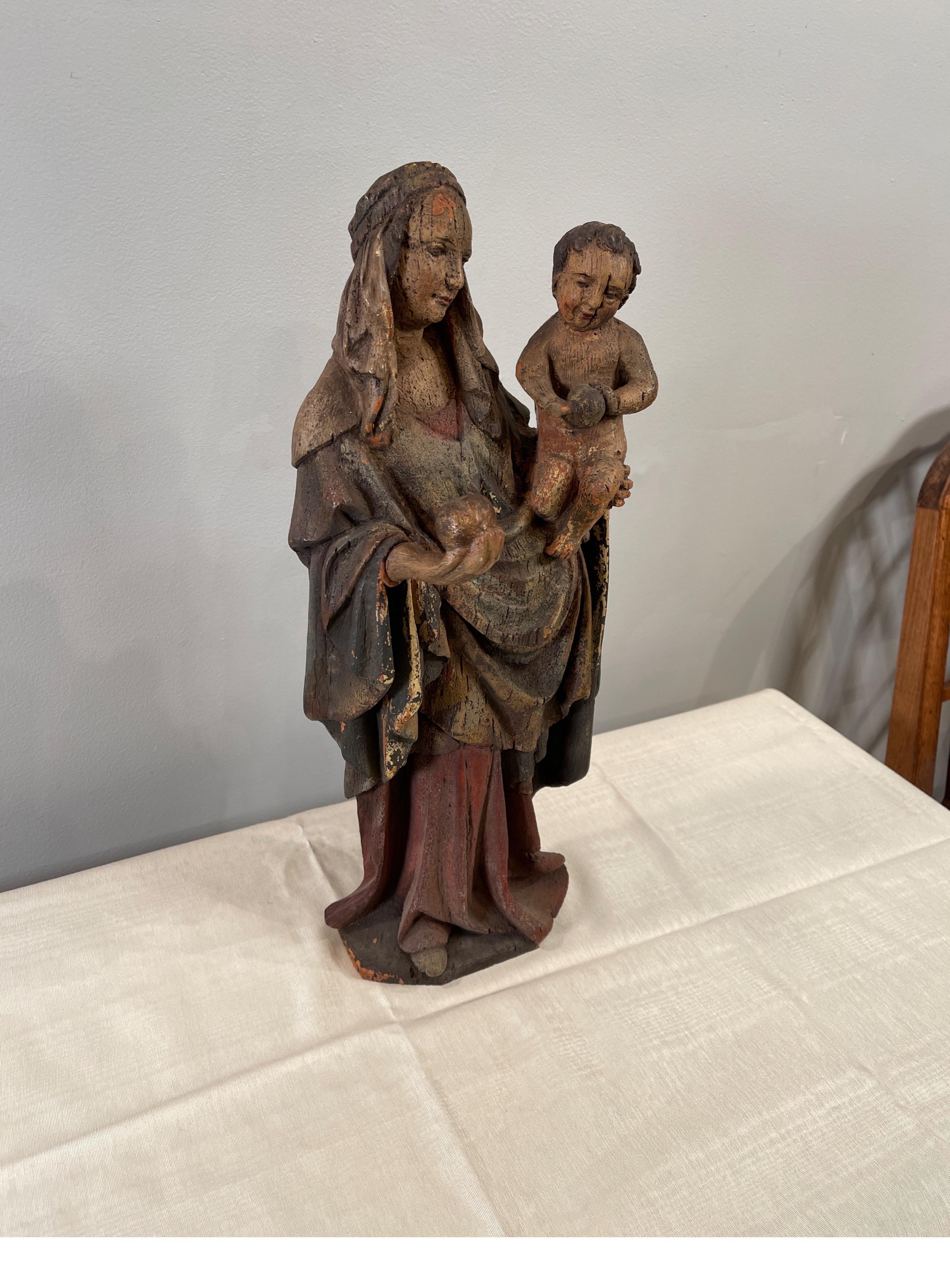 Nineteenth century carved & painted figure of a Madonna & Child each with a sphere in hand, probably Italian.