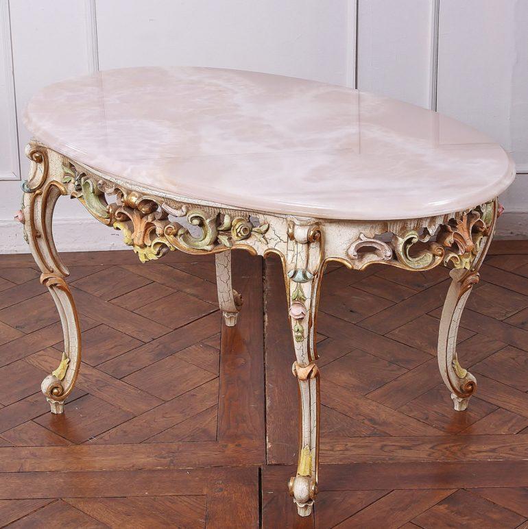 Carved-and-painted onyx-top coffee table with distinctive carvings and coloring and delicately fluted legs. From Paris.



  