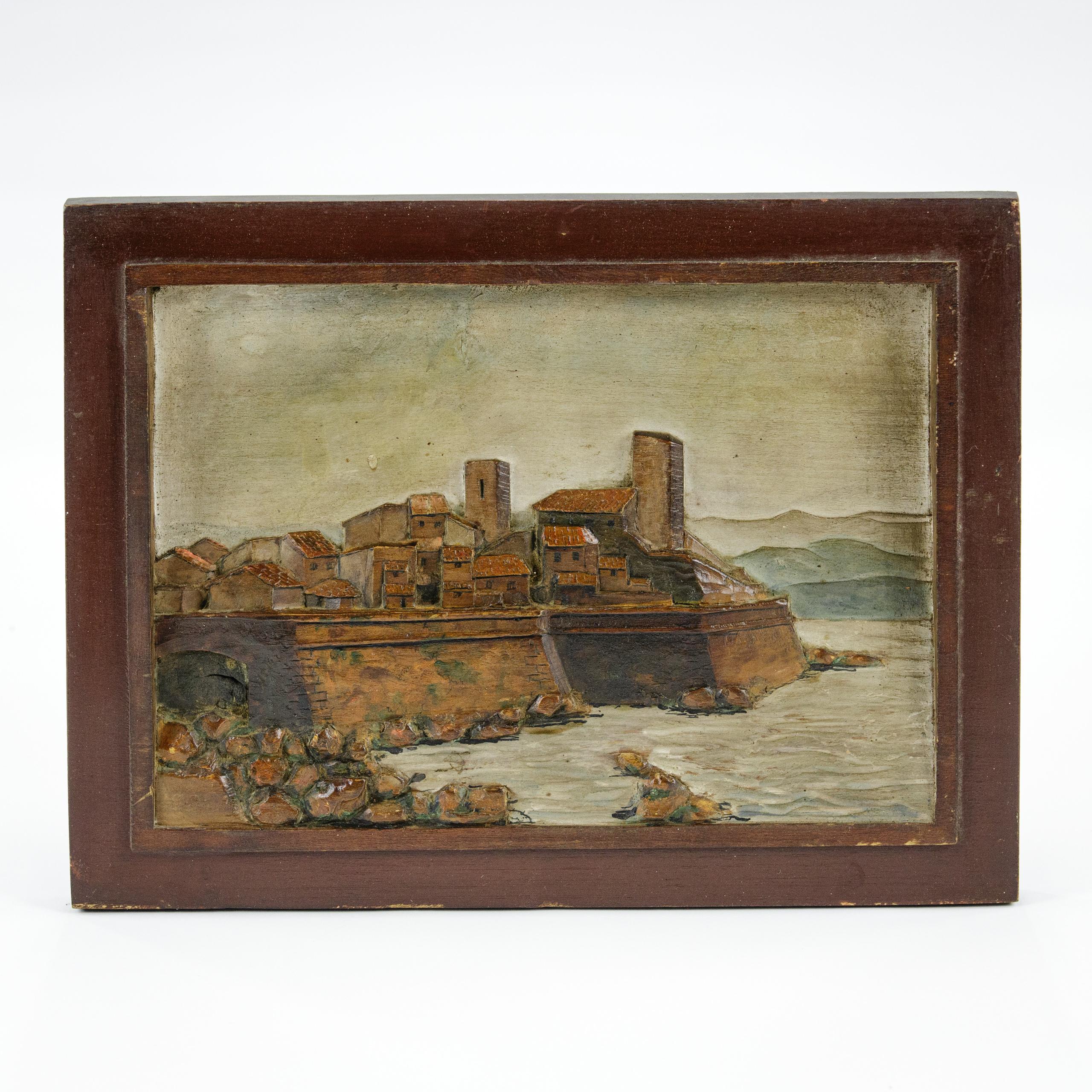 Carved and Painted Relief Land and Seascape of the Old Town and Sea Wall at Antibes. Impressive Carved relief panel of the sea wall looking back at the old town of Antibes in the French Riviera. The intricate carving enlivened with a painted finish,