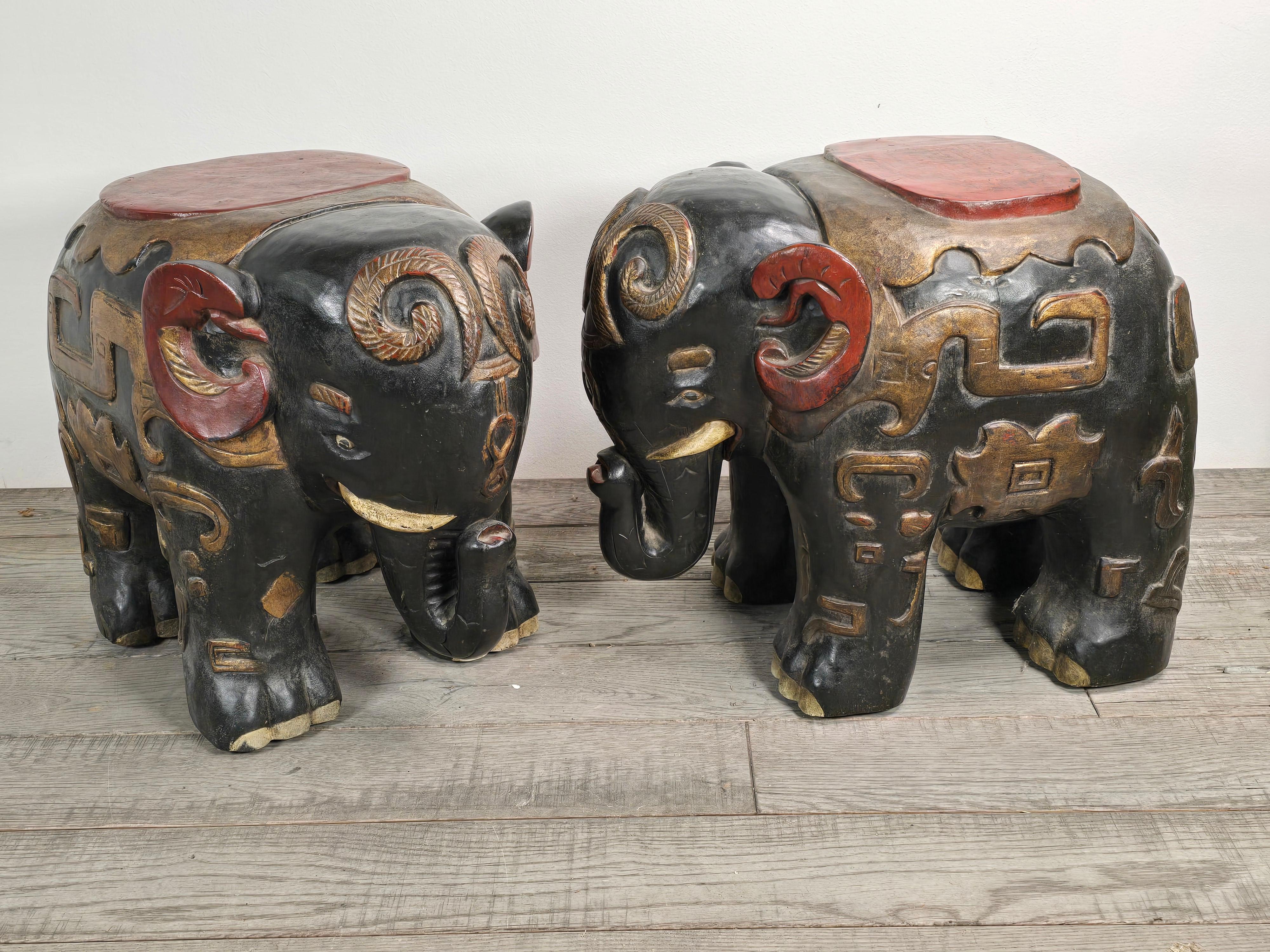 Stunning chinoiserie carved hardwood and lacquered and gilded elephant occasional tables.  The finish has developed over the years into a beautiful patina.  I personally used these as drink table for the last 15 years.   They're beautiful and like