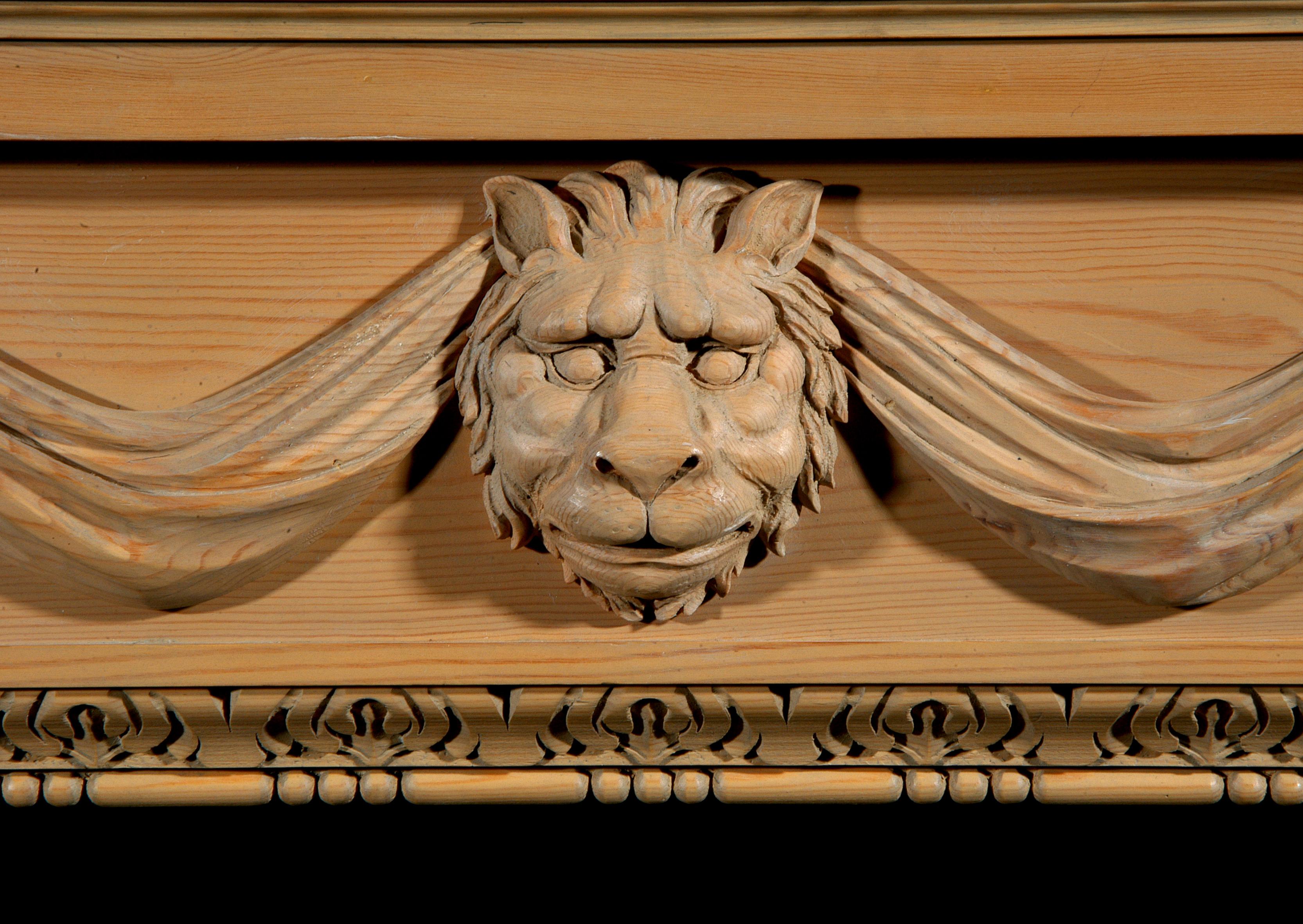 English Carved Pine Fireplace with Lion's Mask and Drapery For Sale