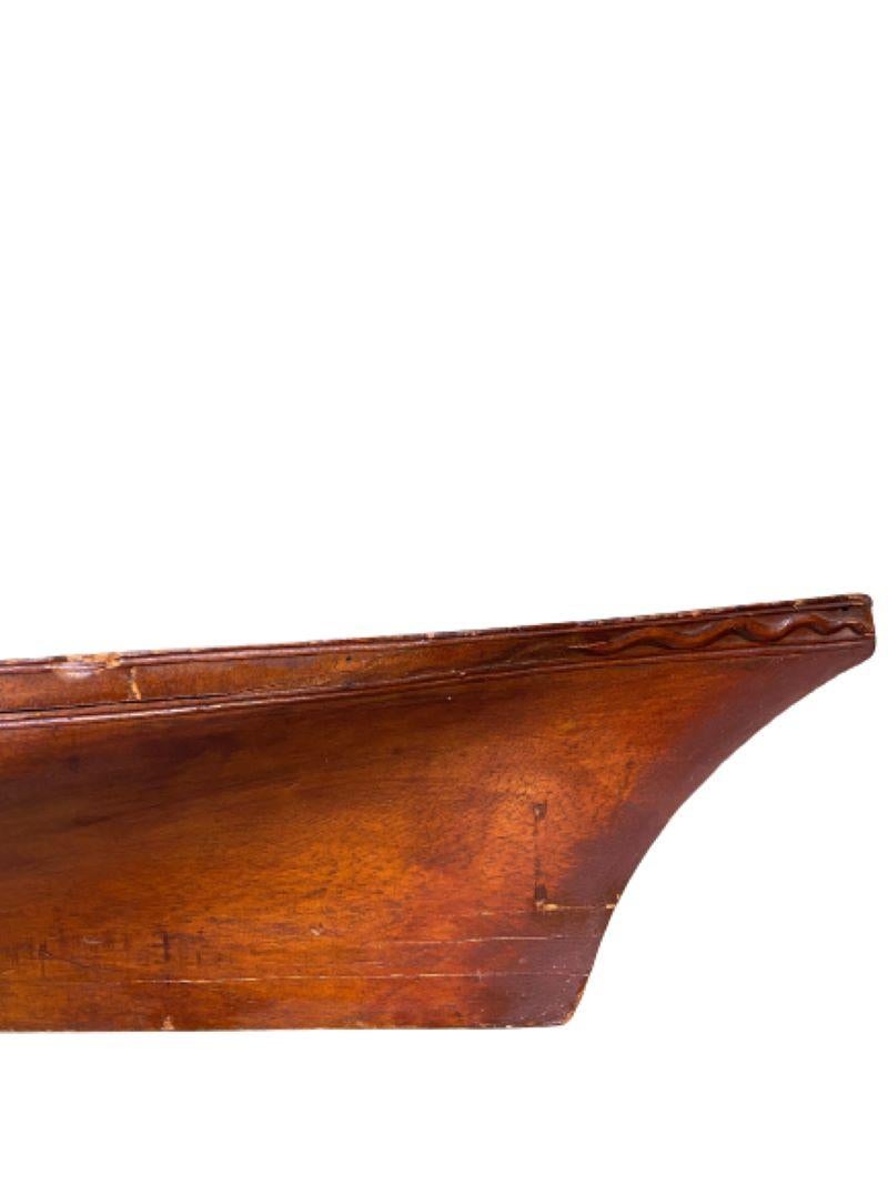 Antique Carved Pine Half Hull Model of a Coasting Schooner, circa 1920, a hollow-carved shell half hull model with clipper bow and great shear, and nice serpentine carved trailboard. This is a very elegant and well carved model of what was a