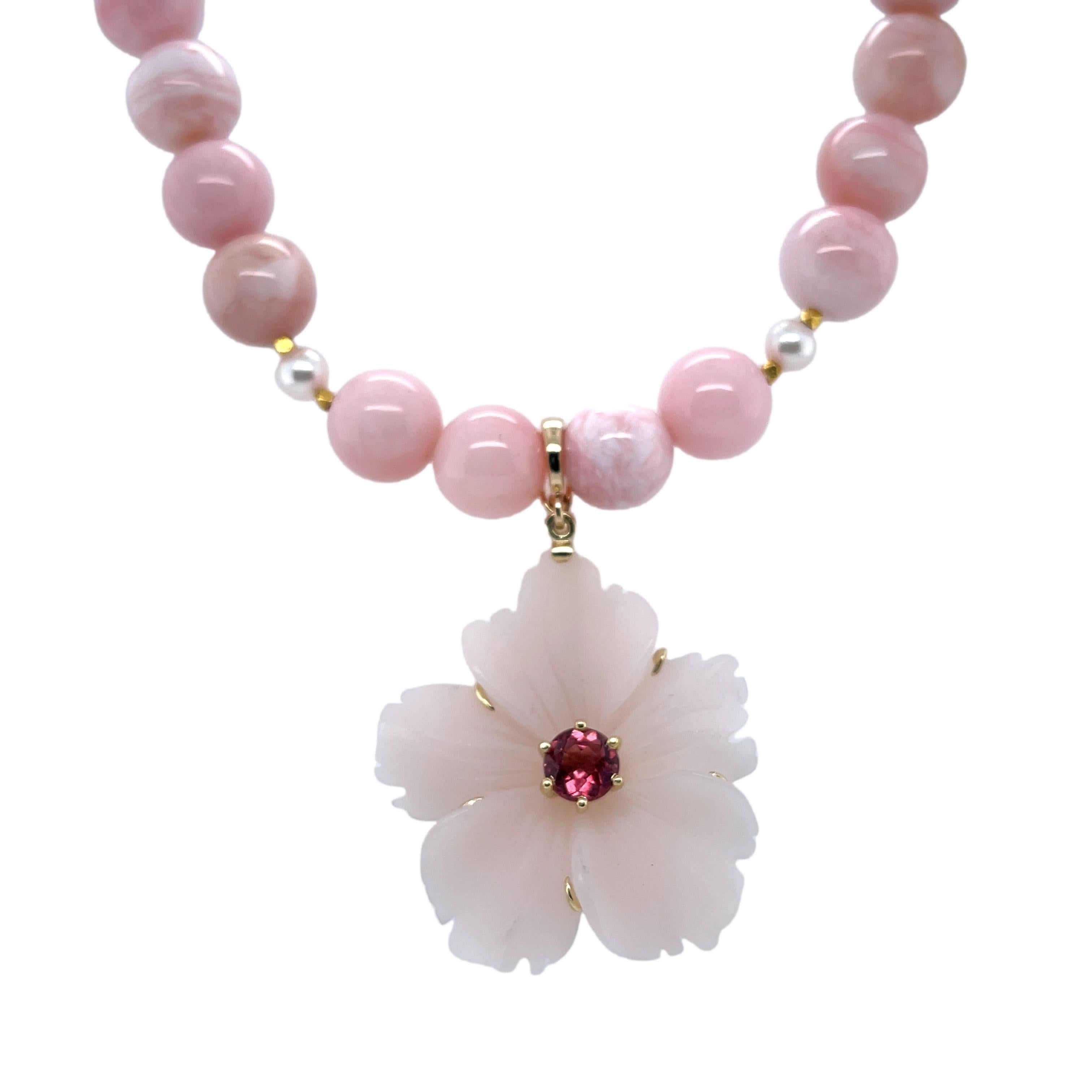 This beautiful pink gemstone necklace pairs a lovely flower pendant carved from a single piece of  