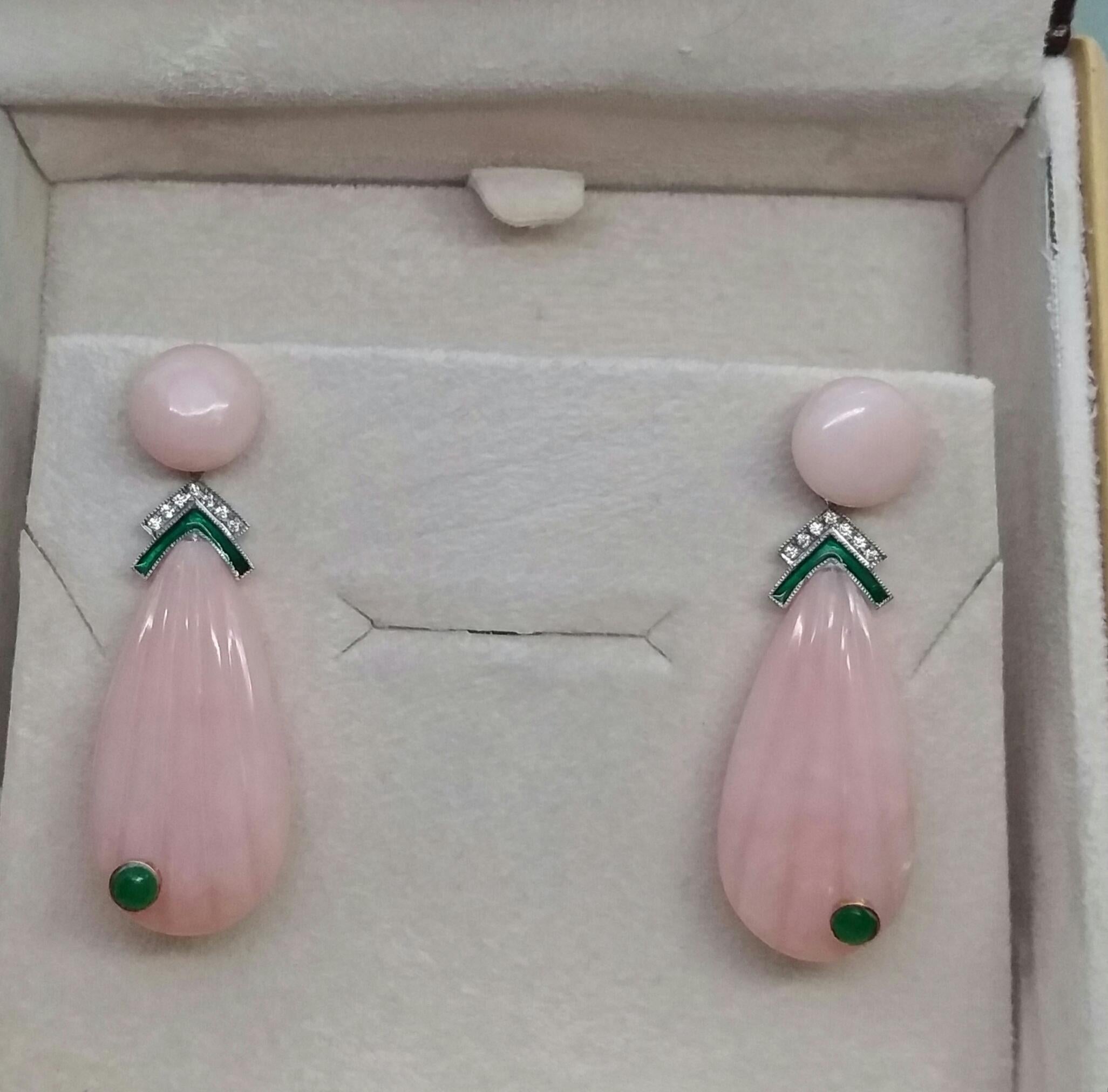 In these classic Art Deco Style earrings the tops are 2 round Pink Opal buttons of 10 mm in diameter,in the middle parts we have 2 white gold elements with small full cut round diamonds and green enamel , the bottom parts are 2 engraved  Pink Opal