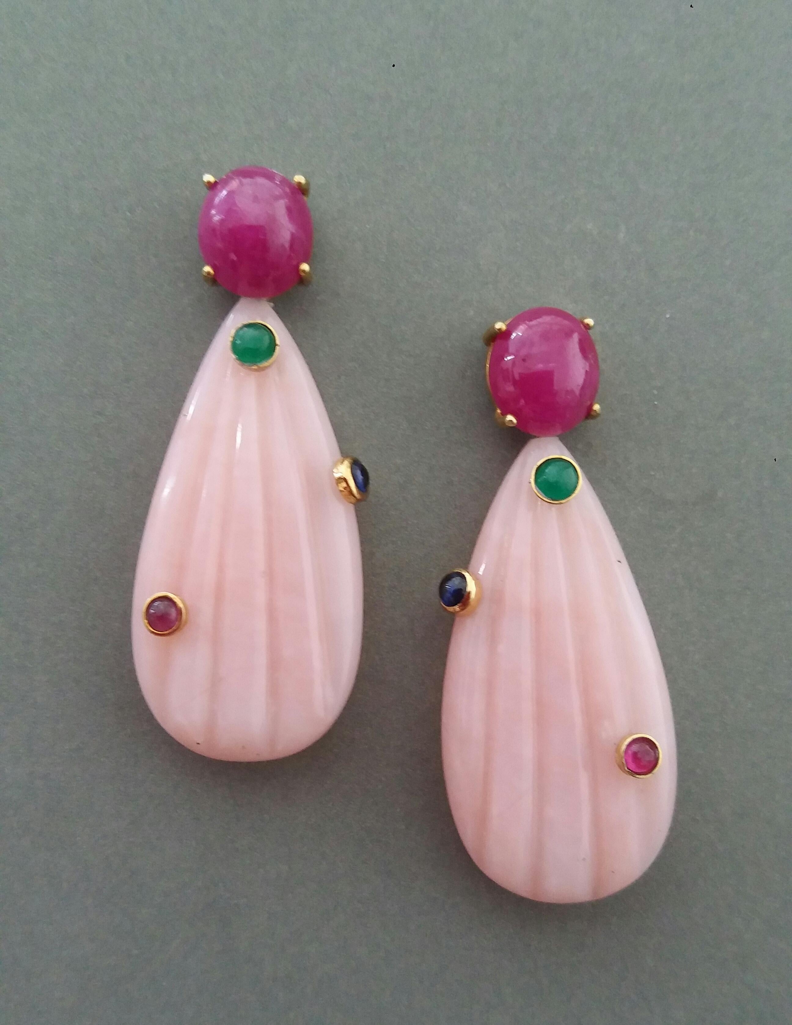 SHIPPING+CUSTOM DUTY ARE PAID BY SELLER

Unique earrings with a pair of Ruby  oval cabochon size 10 x 11 mm set in 14 kt solid yellow gold on the top and 6 small round ruby,blue sapphire and emerald cabochons set in 2 Pink Opal engraved flat drops