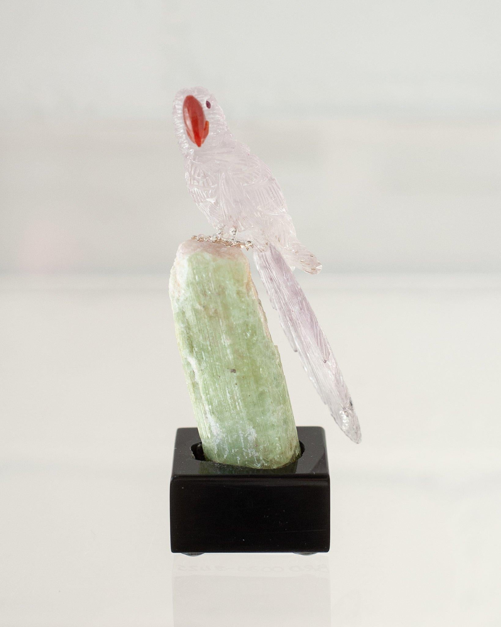 A beautiful hand carved semi precious purple amethyst Macaw mounted on a white green quartz mineral specimen base. This exotic bird is a decorative combination of ornithology and geology.