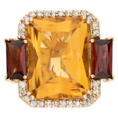 Carved ring in yellow gold with citrine, deep red garnet, and accent diamonds.