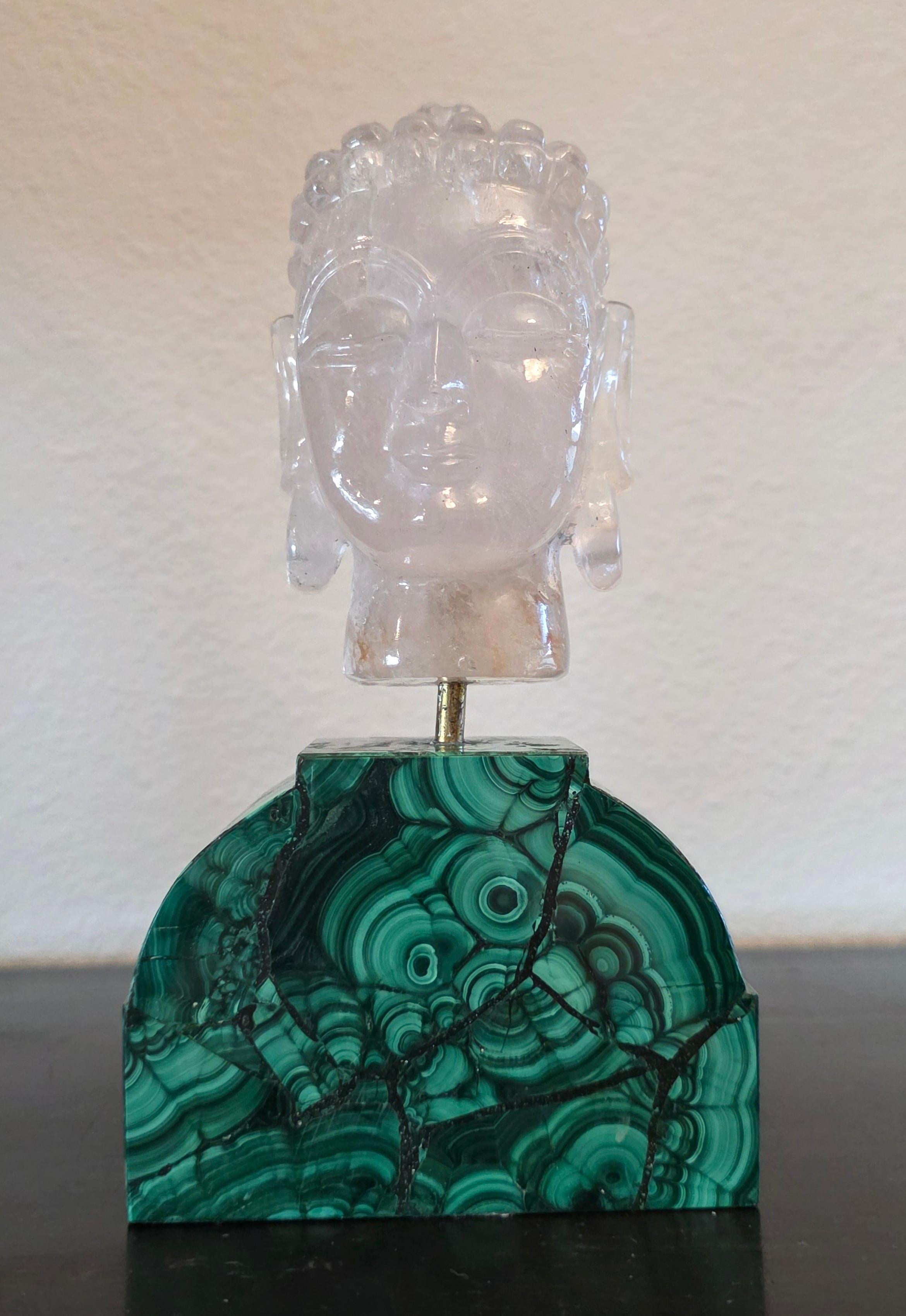 A rare and extraordinary finely hand carved rock crystal sculpture depicting head of the Buddha, with intricate facial details and serene expression with downcast eyes, tightly curled hair with domed ushnisha, and elongated earlobes, mounted on a
