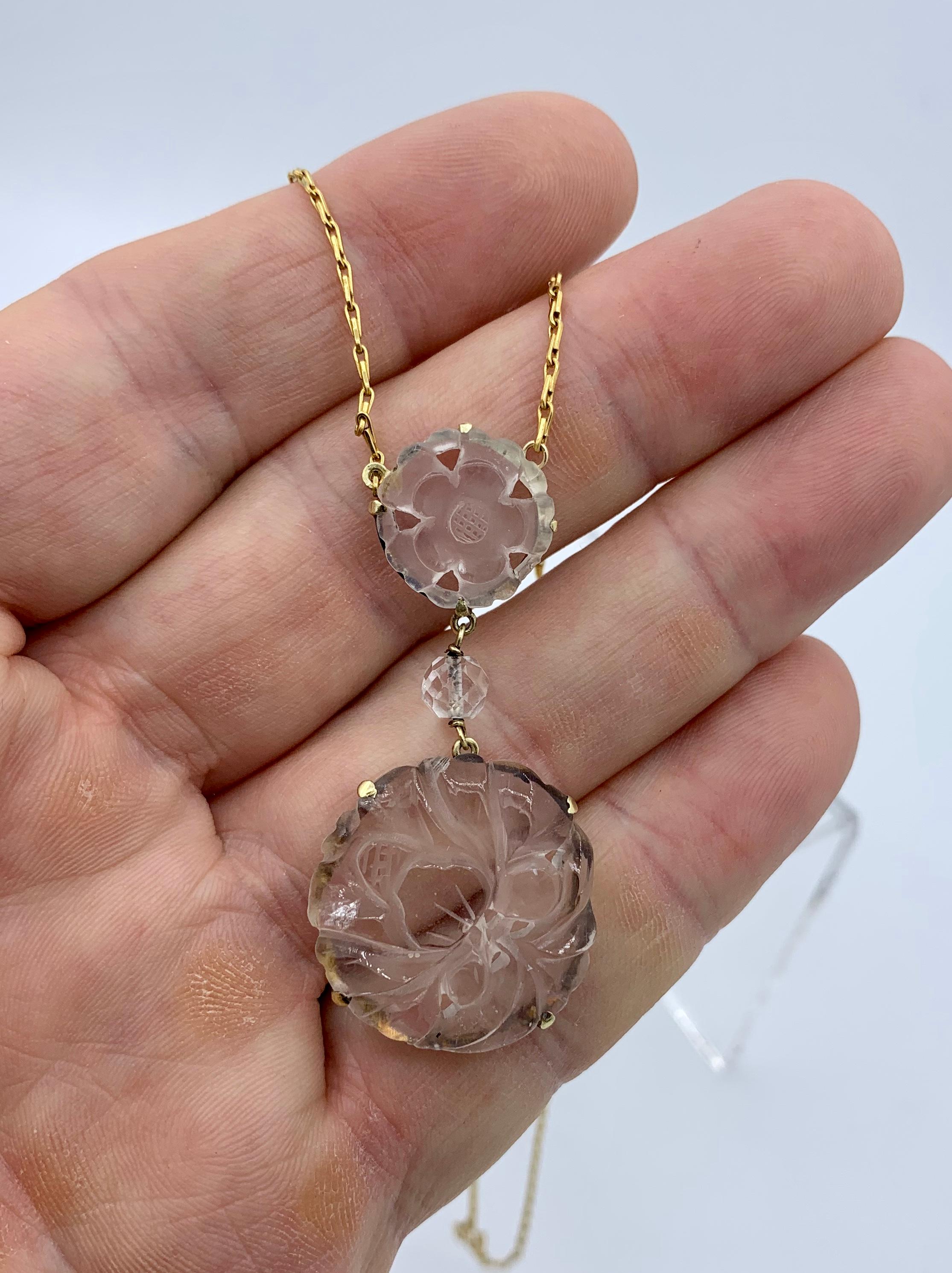 This is a stunning Carved Rock Crystal Station Necklace in 14 Karat Yellow Gold.  The rock crystal pendants are carved with a nature inspired flower and leaf motif that is just stunning.  There are faceted rock crystal bead stations within the