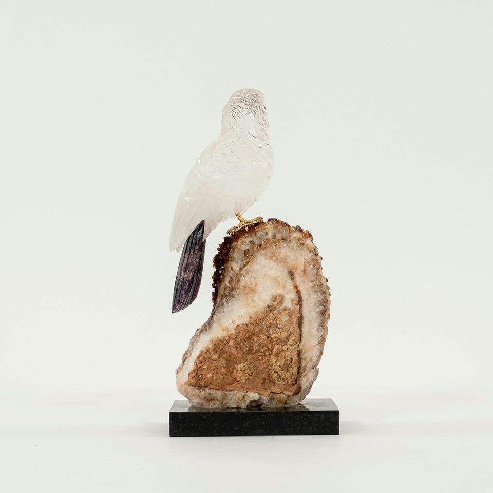 An intricately carved rock crystal cockatoo with amethyst tail, garnet eyes, agate beak and gilt bronze feet perched on a citrine druzy specimen. Superior workmanship and semi-precious gemstones makes this a great addition to any collector or bird