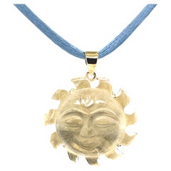 Carved Rock Crystal "Sun Face" and 18k Yellow Gold Pendant with Blue Silk Cord
