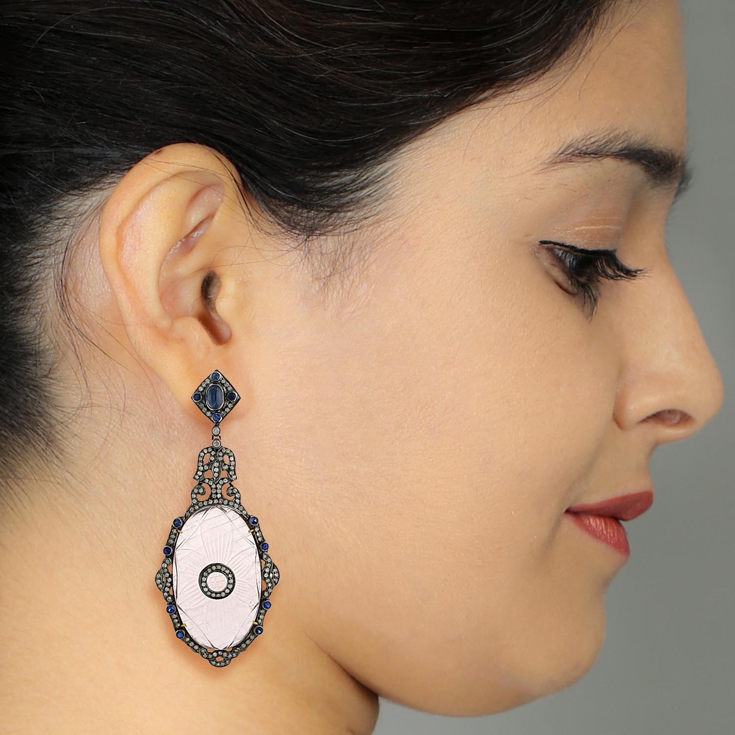 This too cool for summer Carved Rose Quartz Earring with Diamonds and Blue Sapphire in gold and silver will be the prettiest earring you have seen lately.

Closure: Push Post

18Kt: 1.67g
Diamond: 2.92Ct
Silver: 18.16g
BLUE SAPPHIRE: 3.8Ct
ROSE