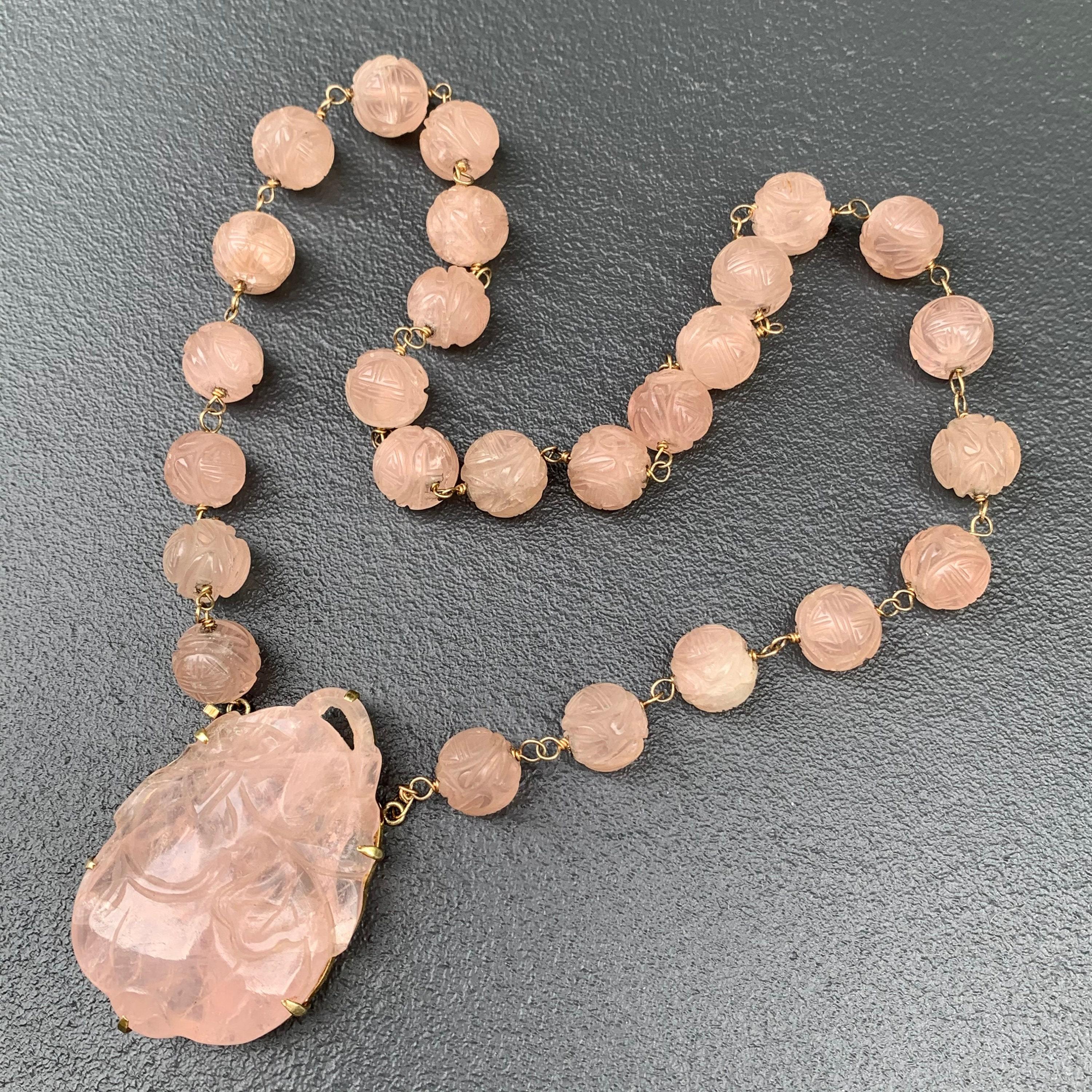A beautifully crafted Art Deco necklace featuring hand-wired 14kt gold and carved rose quartz beads. Each bead is intricately carved with the Chinese 