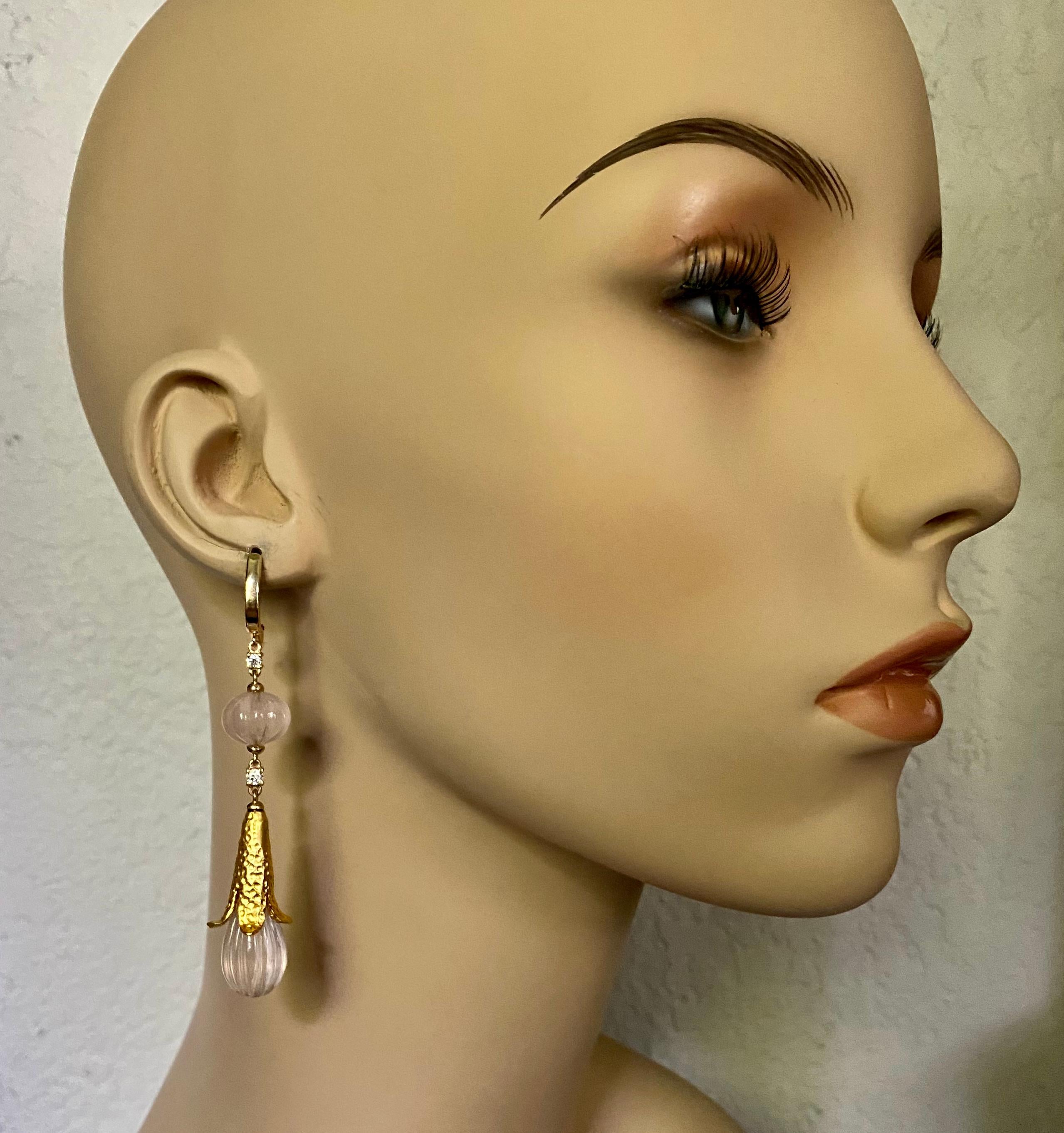 Rose quartz is featured in these delicate yet dramatic Mughal style dangle earrings.  The rose quartz was melon carved and expertly finished in India.  Complimenting the gems are brilliant cut white diamonds.  The quartz drops are mounted in