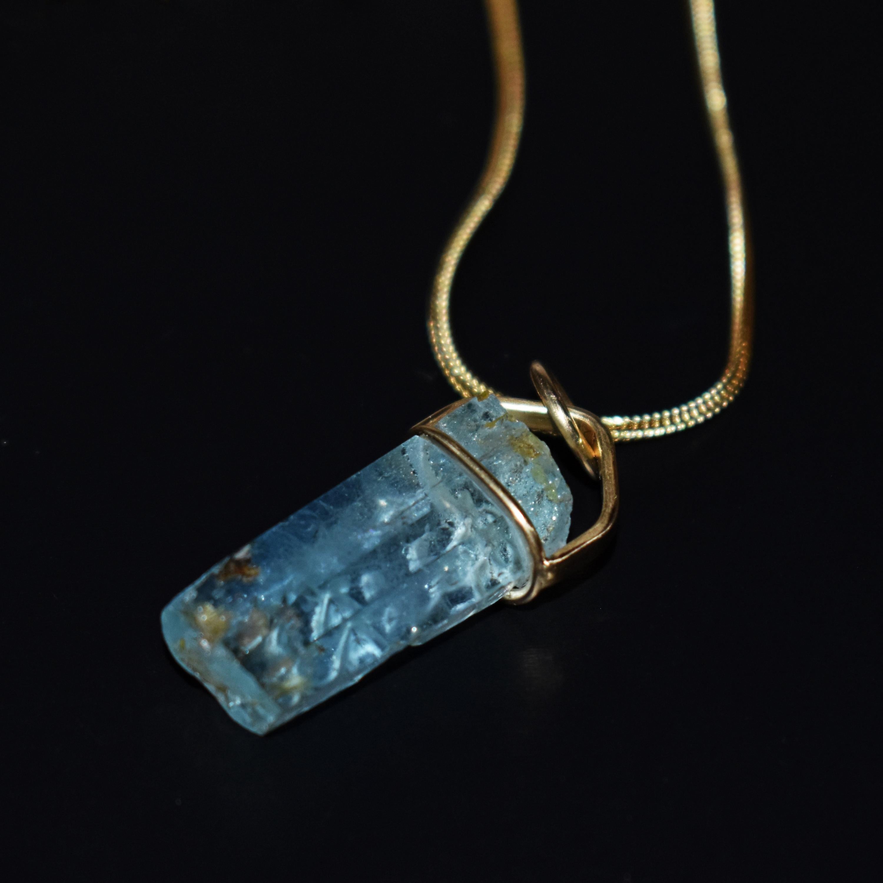 Beautiful hand-carved, rough Aquamarine crystal and 18k yellow gold pendant on a 16 inch 18k gold foxtail chain necklace. Aquamarine pendant, including bail, is 1.44 inches or 37mm in length. Gorgeous, carved vine design in this sky blue Aquamarine