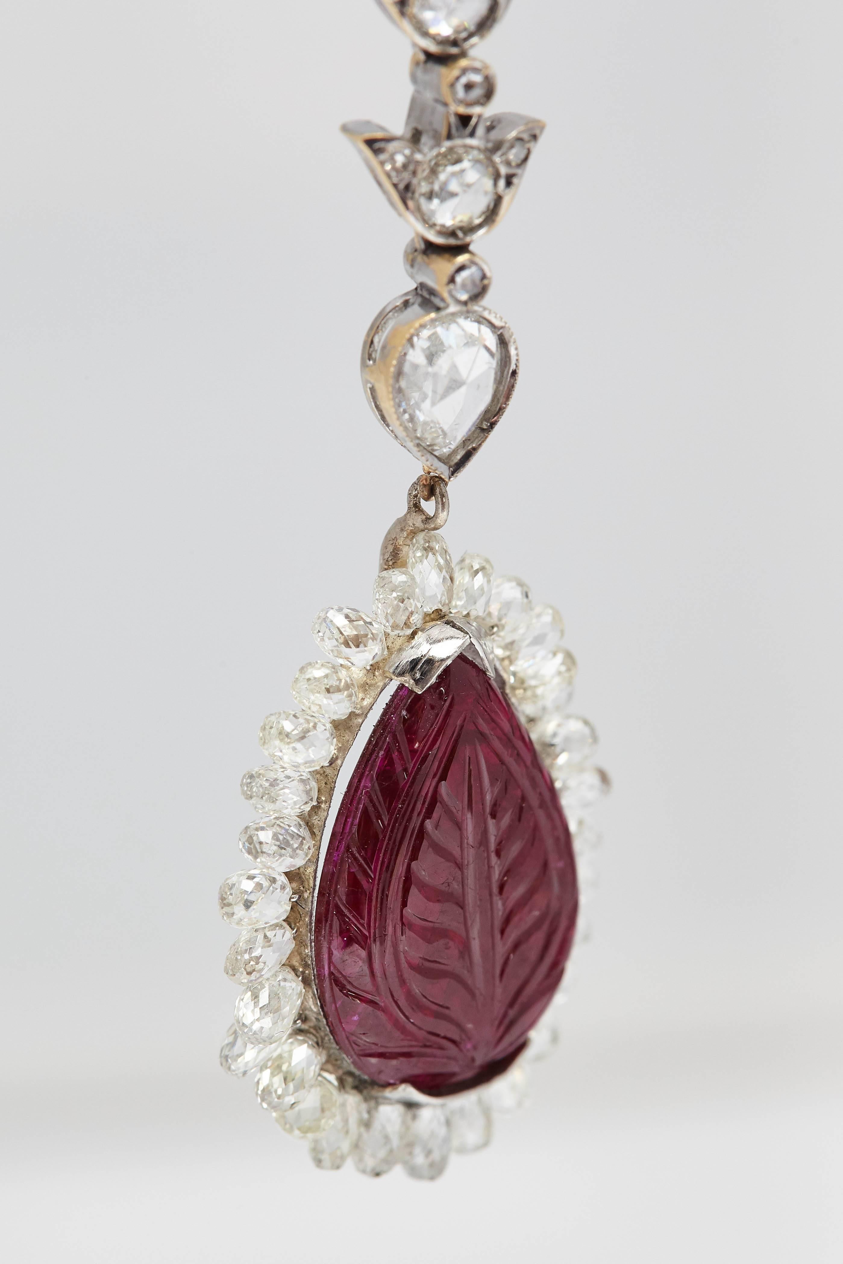 A pair of ear-pendants with diamond briolettes (app. 12 cts) and leaf shaped carved rubies, mounted on 18k white gold. Made in Italy, circa 1980 