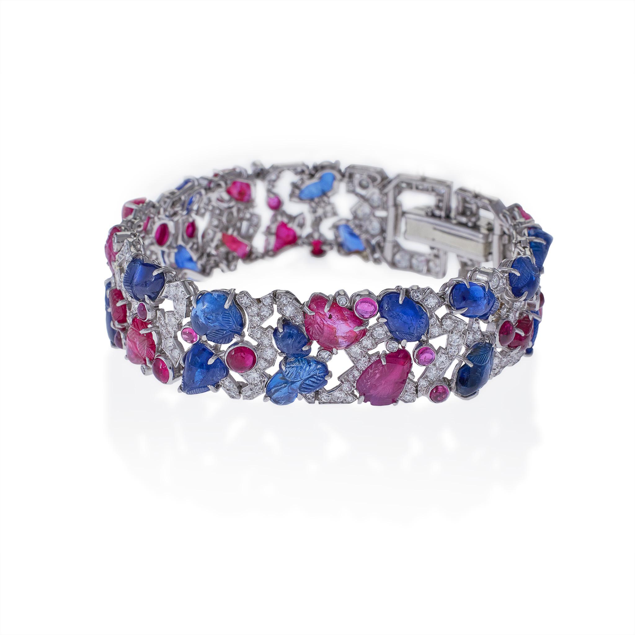 

Created in the 1920s, this Art Deco “tutti frutti” strap bracelet is composed of sapphires, rubies, diamonds, and platinum. It is designed as a highly stylized diamond vine with carved ruby and sapphire leaves and cabochon ruby berries, completed