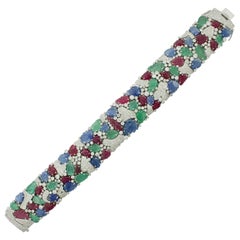 Carved Ruby, Sapphire, Emerald and Diamond “Tutti Frutti” Bracelet in 18 Karat