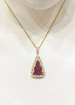Carved Ruby with Diamond Buddha Pendant set in 18K Gold Settings