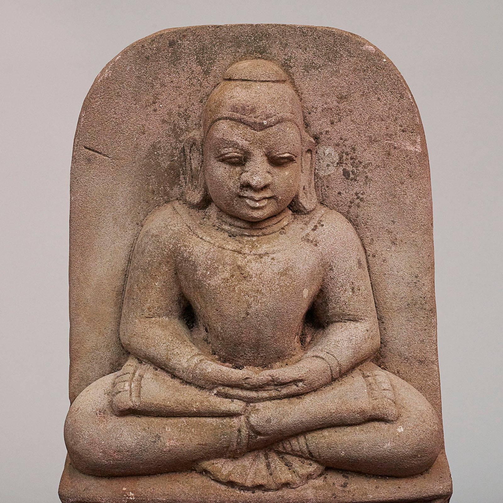A powerful carved sandstone Burmese Buddha, circa 1600-1700, carved in meditation with crossed legs and arms referred to as 