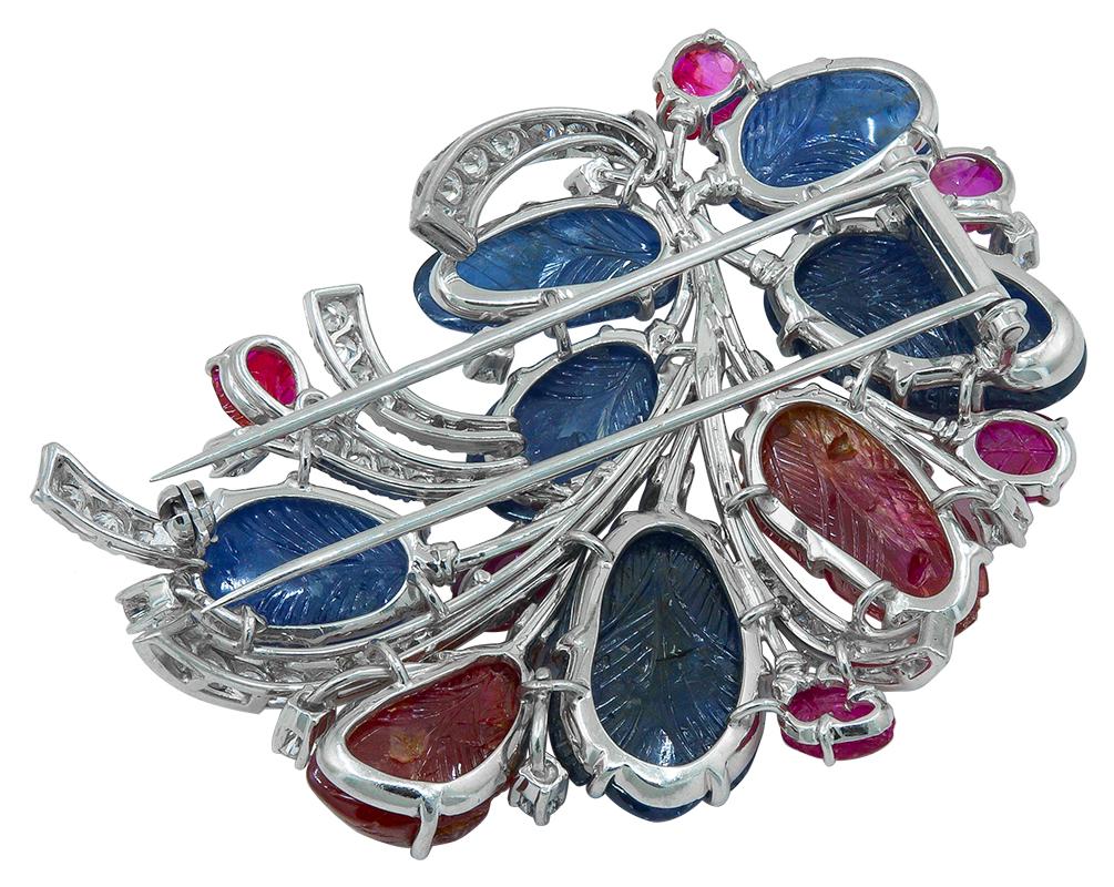 Carved Sapphire Ruby Diamond Flower Brooch in Platinum.

This Carved Sapphire Ruby Diamond Flower Brooch in Platinum captures the moment when nature transitions from winter to spring. Budding petals of hand-sculpted sapphires and rubies emerge from