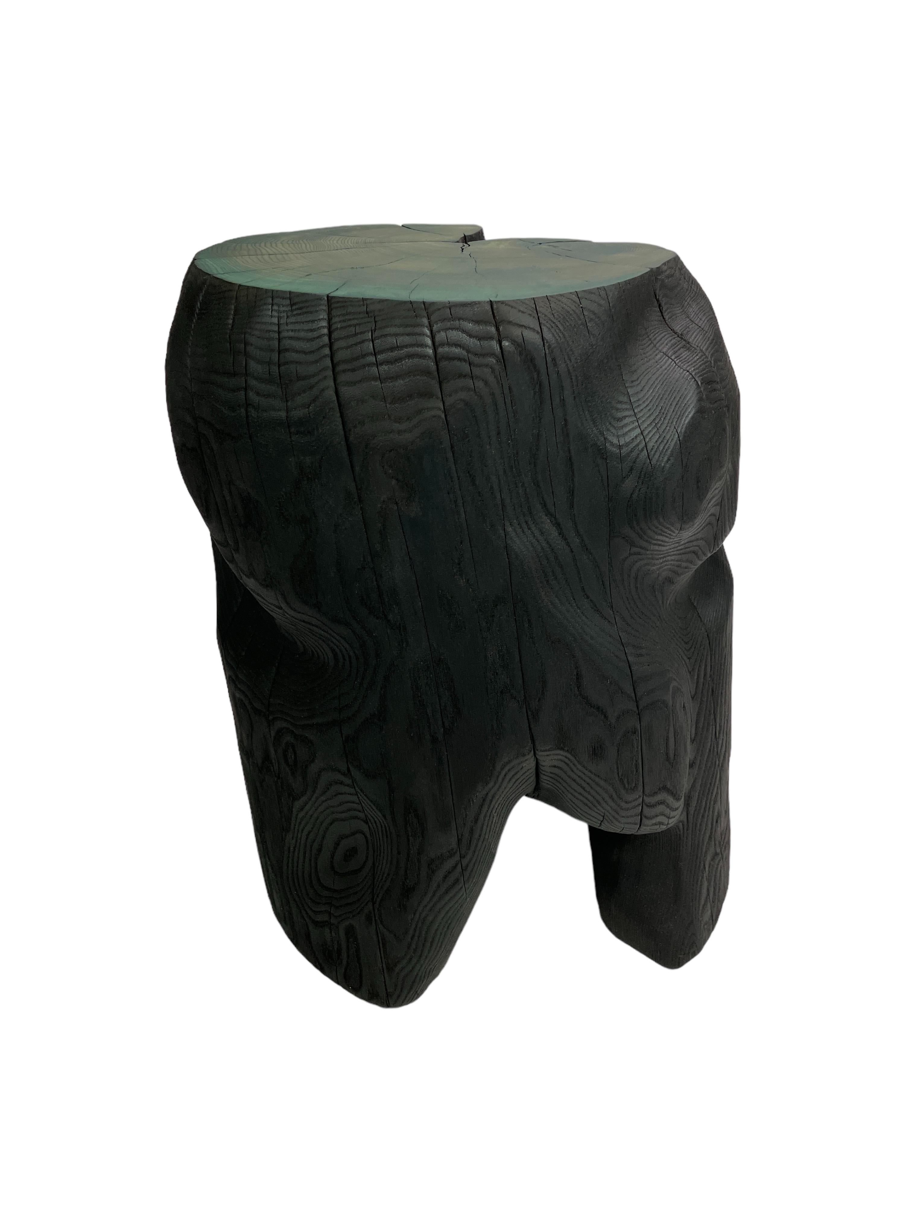 Carved sculptural contemporary wooden stool/table from locally sourced elmwood in Sweden. Hand carved by master Swedish woodmaker ELAKFORM. The organic form is charred and treated with linseed-oil. The top is finished with a green smooth surface