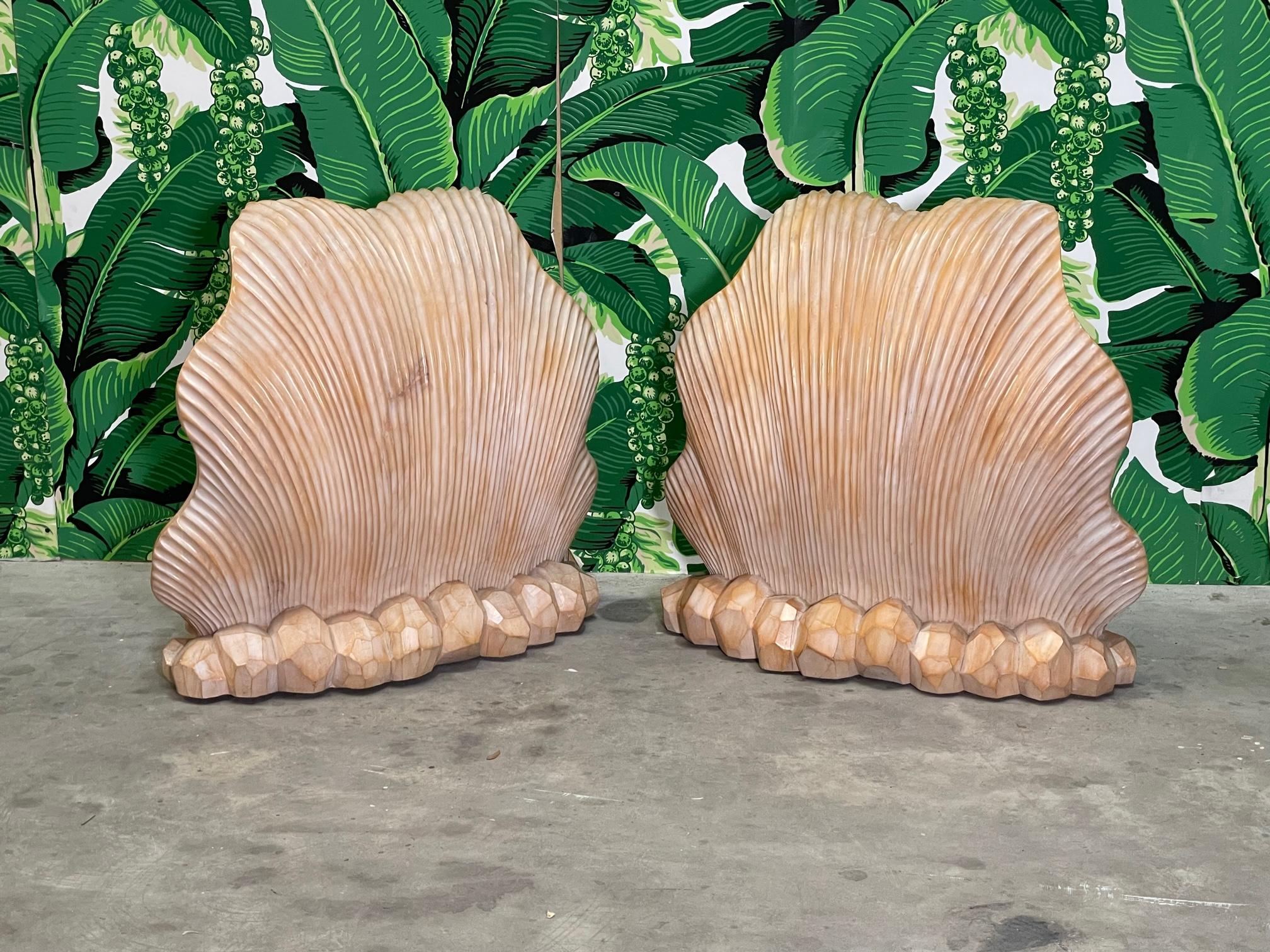 Large double base dining table features twin carved wood sea shell bases and beveled glass top. In the manner of Serge Roche. Bases in very good condition and glass has two very small chips (see example in photo). We also have matching chairs (see