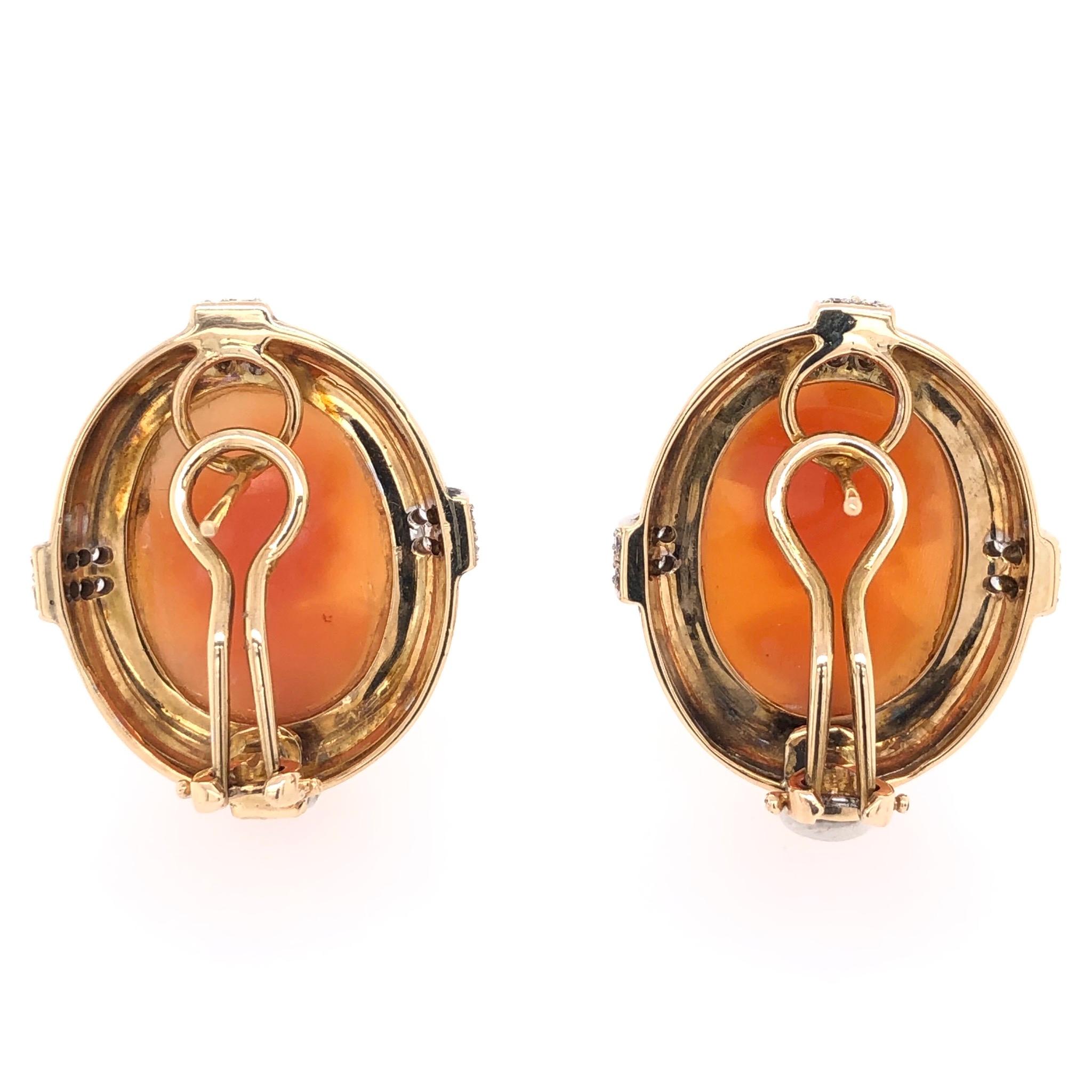 Lovely Hand Carved Shell Cameo Earrings, set in Beautiful Hand crafted 14 Karat Yellow Gold surrounds, accented by Diamonds, approx. 0.64tcw. Measuring approx. 1.1” tall. In excellent condition, recently professionally cleaned and polished. These