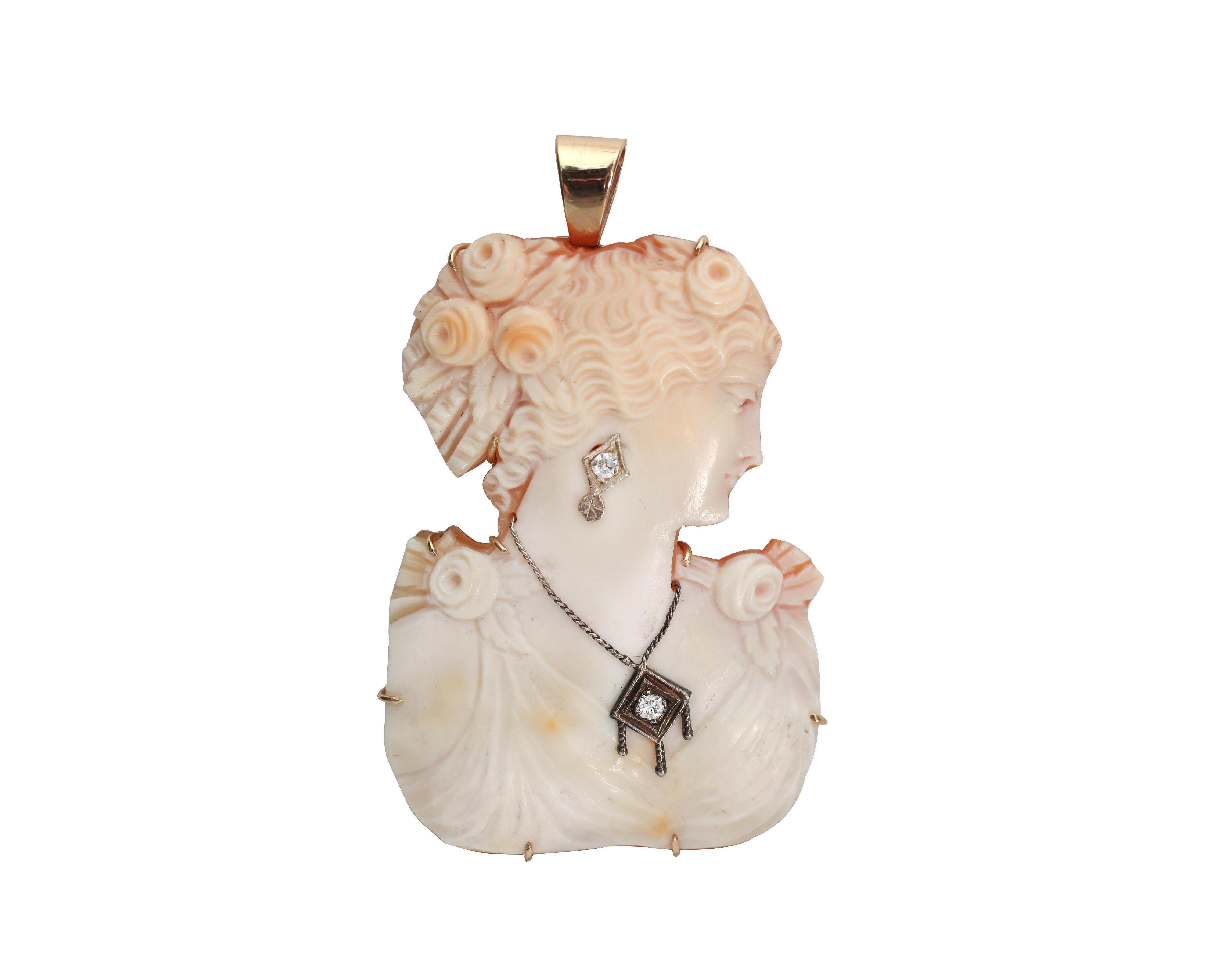 Description: 
This intricately carved shell cameo pendant is as stunning as it is unique. It features 2 diamond accents along with 14K white/yellow gold. 

This is a true vintage piece and we are proud to offer it to our 1st Dibs family.   

Item