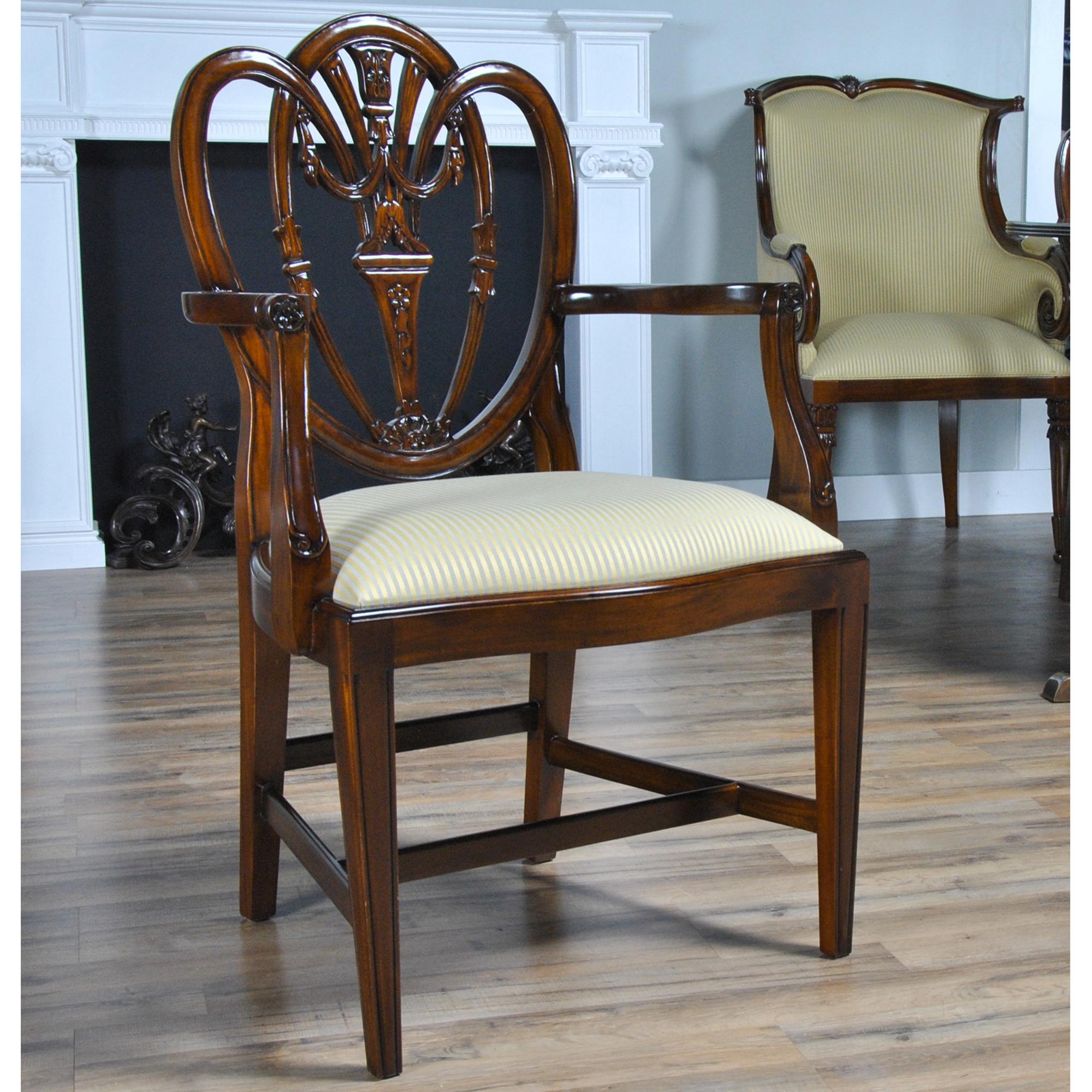 This Set of 10 Carved Shield Back Chairs are slightly larger and heavier than some of our other shield back chairs. The chairs in this set are as pretty as any chair we manufacture. The beautifully decorated back of the chair and the scrolled and