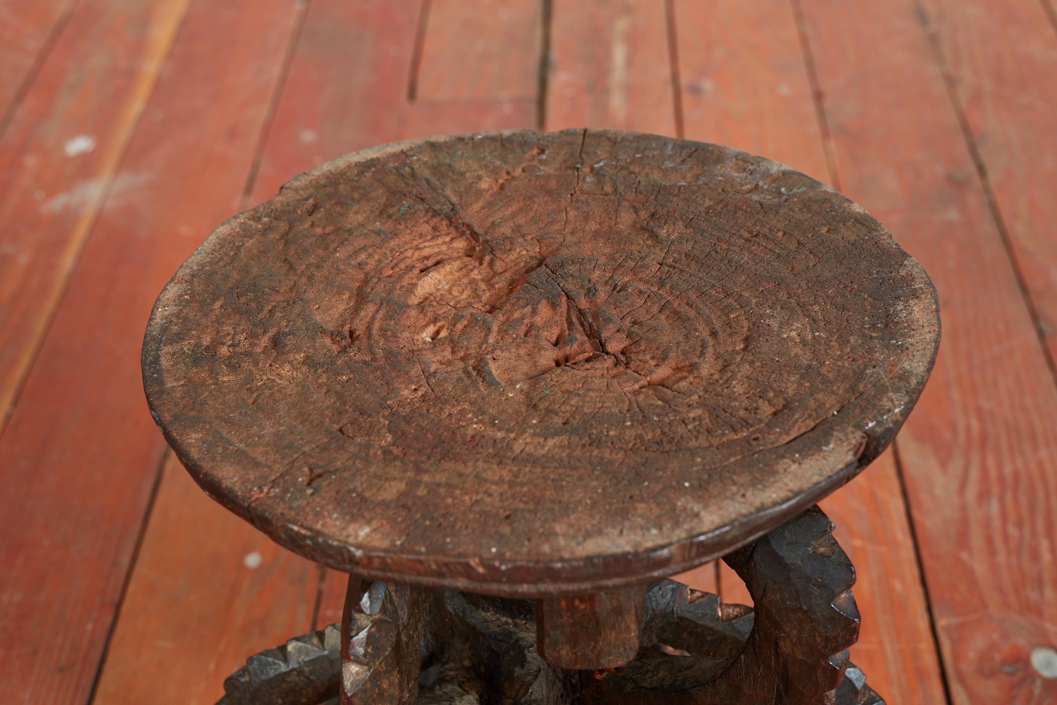 African carved stool or side table with scalloped edges.