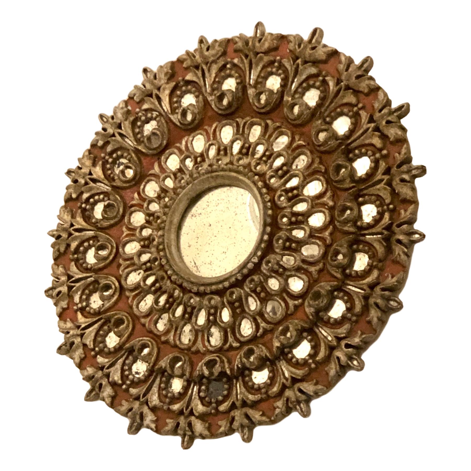 A circa 1940's silver-leaf Italian polychromed mirror with mirror insets.

Measurements:
Diameter: 23.75