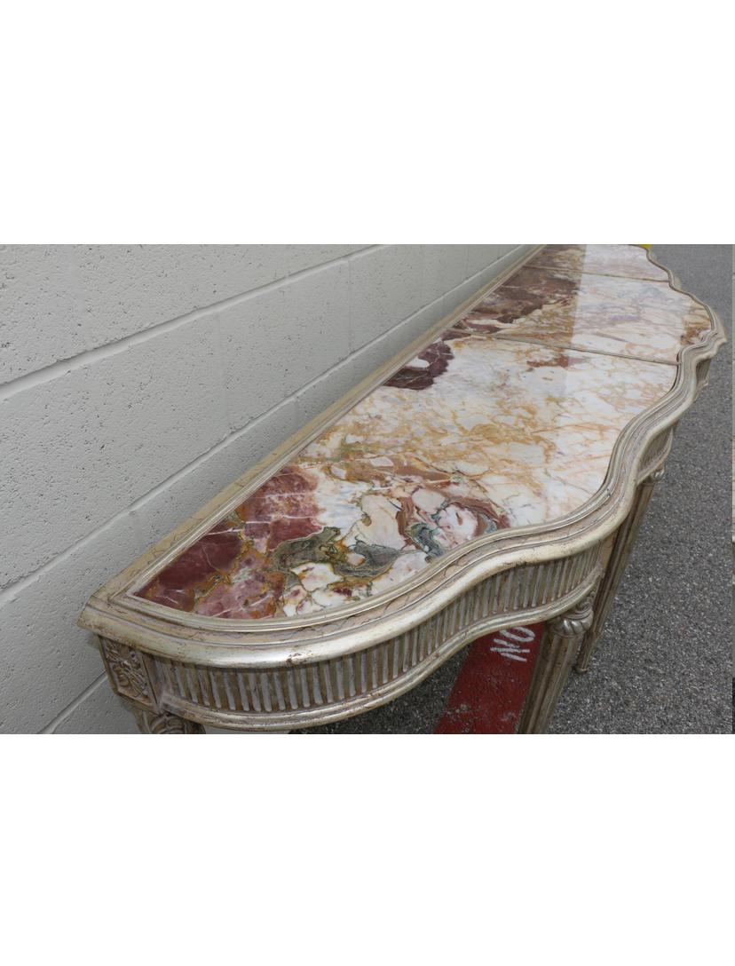 Elegant beautiful wood carved console table with beautiful marble tops in excellent condition. Console table is very sturdy and clean. No damages or missing parts on the carved wood detail.. Great for any entry