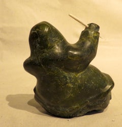 Carved Soapstone Sculpture of a Seated Inuit Holding a Bone Narwhal Tusk & Fish