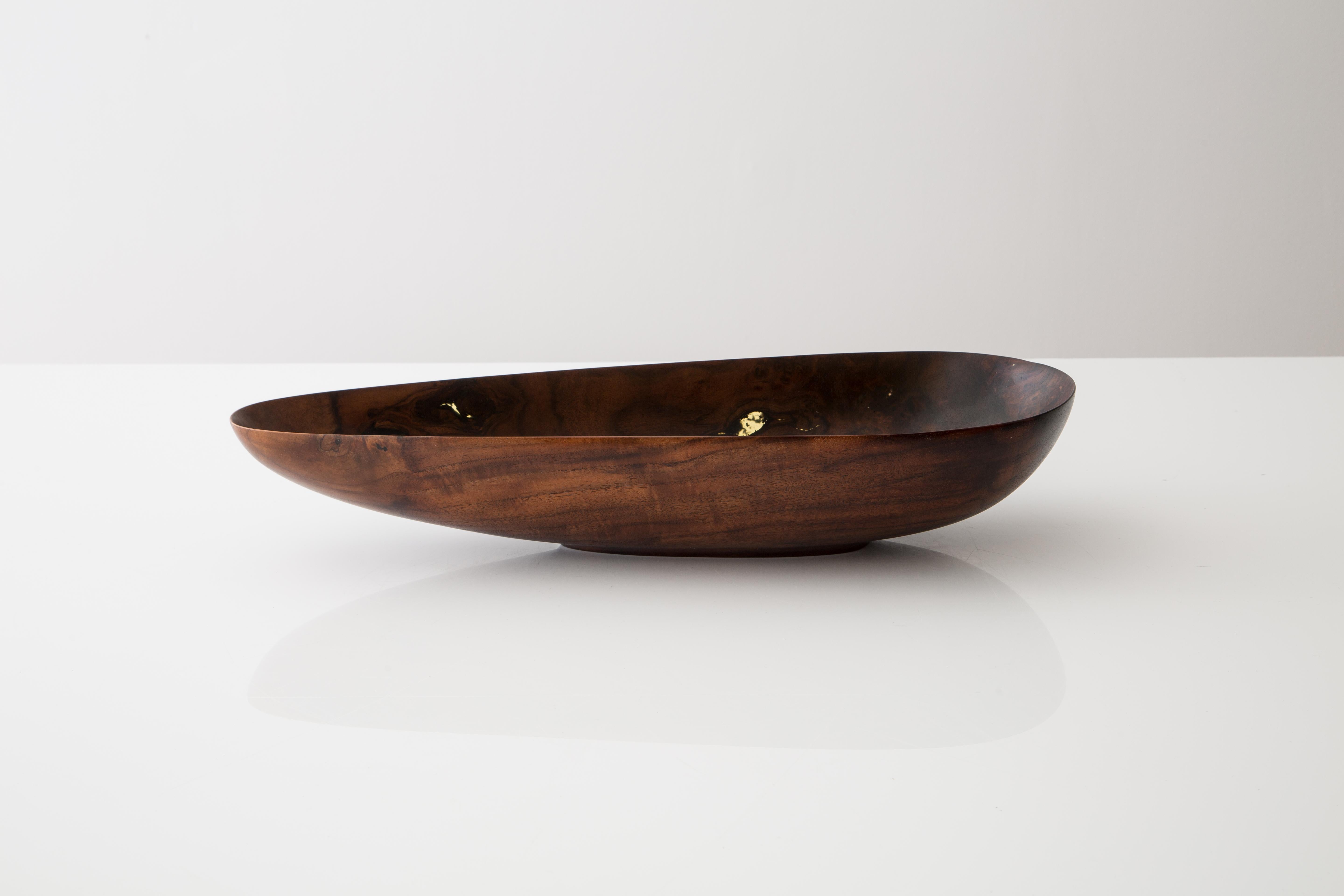 This asymmetrical vessel was been CARVED from a single piece of Claro Walnut salvaged from a firewood pile. The finished bowl highlights everything about what makes Walnut such a desirable wood. The tones and colors range from medium to deep/dark