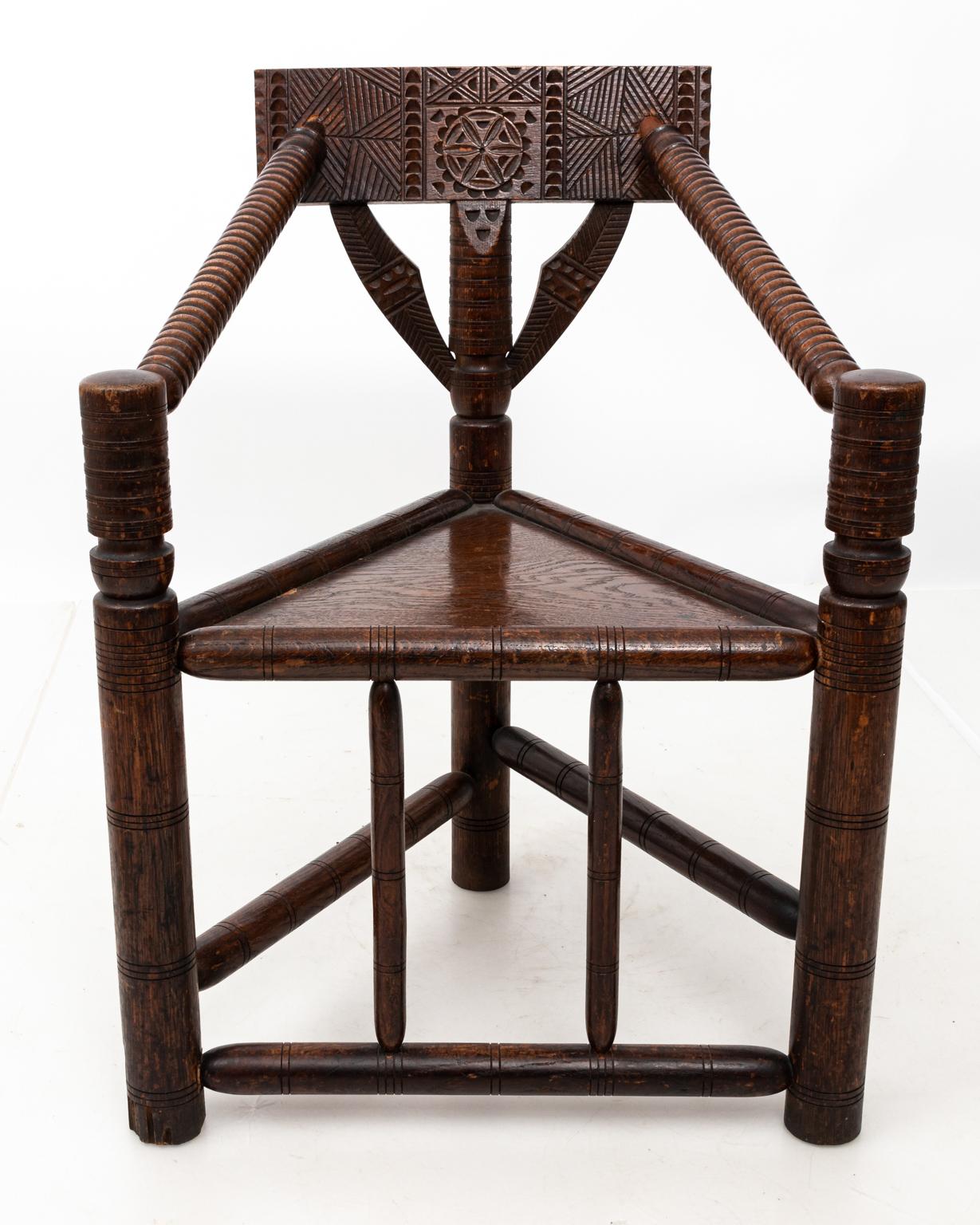 Carved spool armchair with ring turned arms and upholstered, removable cushion. Please note of wear consistent with age including minor finish loss.