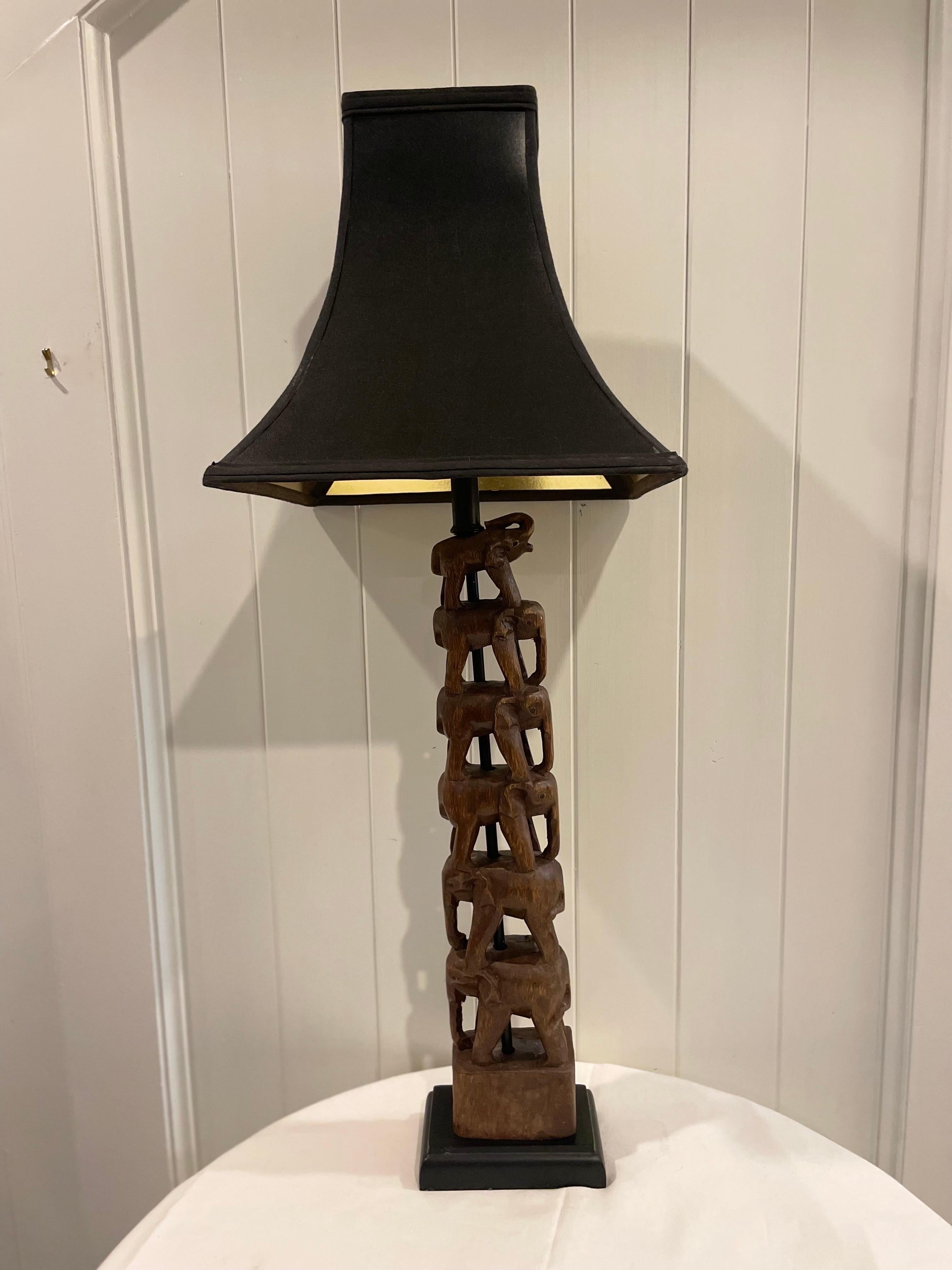 Gorgeous Carved Wood Stacked Elephant Lamp Attributed to Frederick Cooper Original wiring in working condition. Pretty Black shade with gold interior.